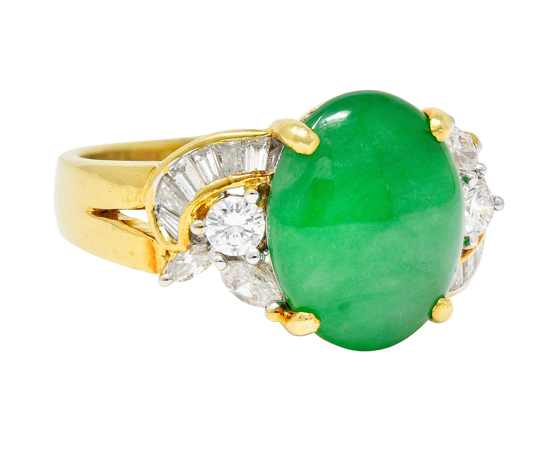 Featuring an oval jadeite jade cabochon measuring approximately 12.0 x 10.0 mm

Translucent and subtly mottled green to medium dark green with no indications of impregnation - type A jade

Basket set and flanked by shoulders clustered with tapered