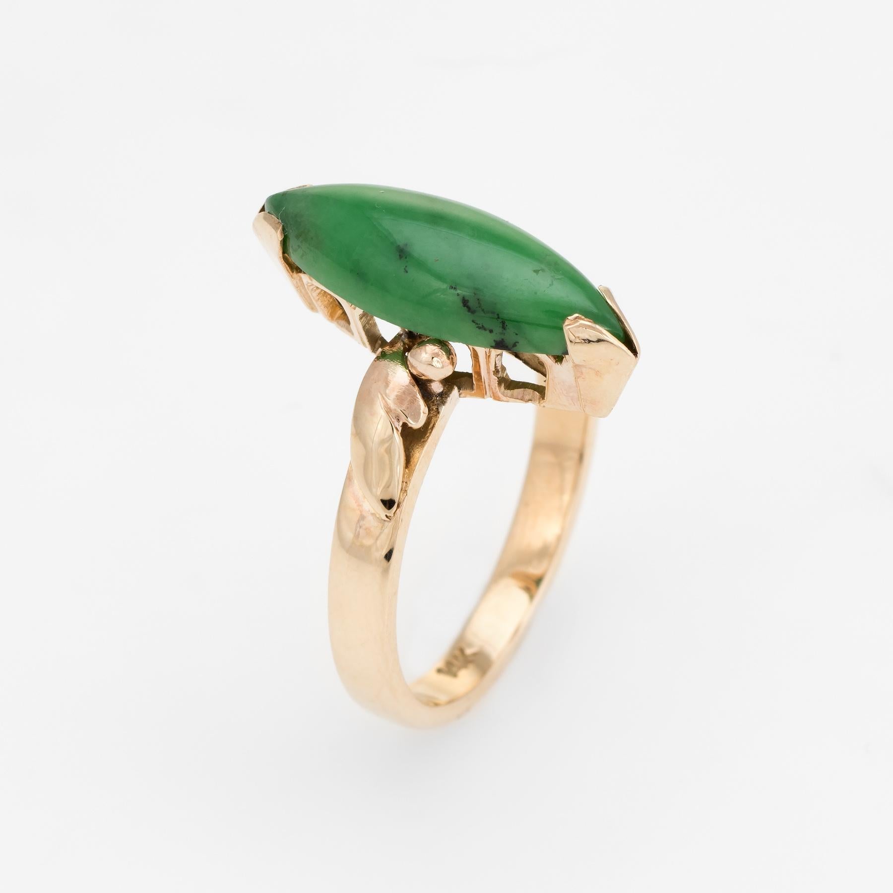 Finely detailed vintage jadeite cocktail ring (circa 1950s to 1960s), crafted in 14 karat yellow gold. 

Cabochon cut jade measures 18mm x 6.5mm (estimated at 3 carats). The jade is in excellent condition and free of cracks or chips. 

The elegant