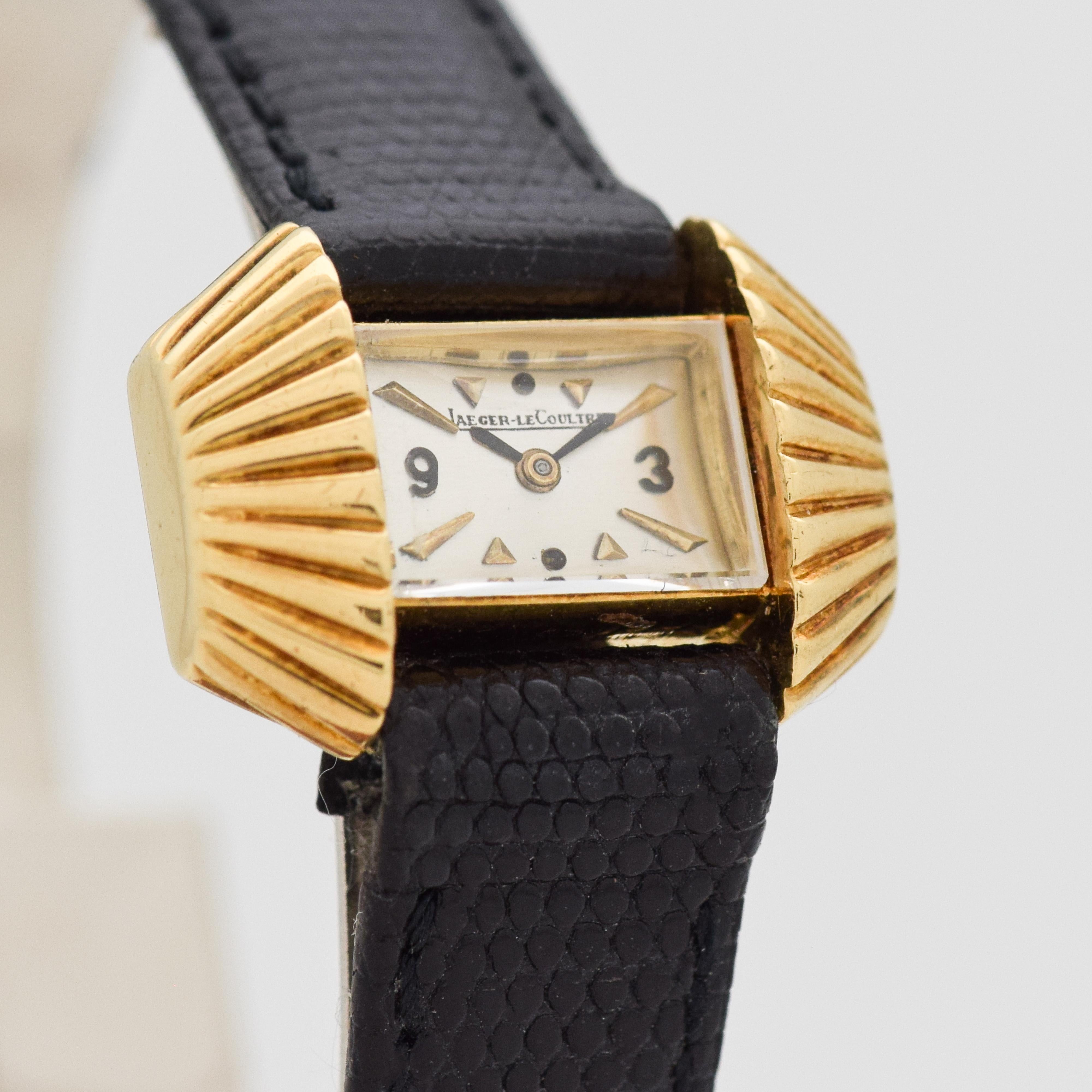 1960's Vintage Jaeger - Le Coultre Ladies 18k Yellow Gold Back Wind watch with Unique Ridged Sides with Silver Dial with Applied 3 and 9 with Beveled Arrow Markers. 23mm x 16mm lug to lug (0.91 in. x 0.63 in.) - 15 jewel, manual caliber movement.