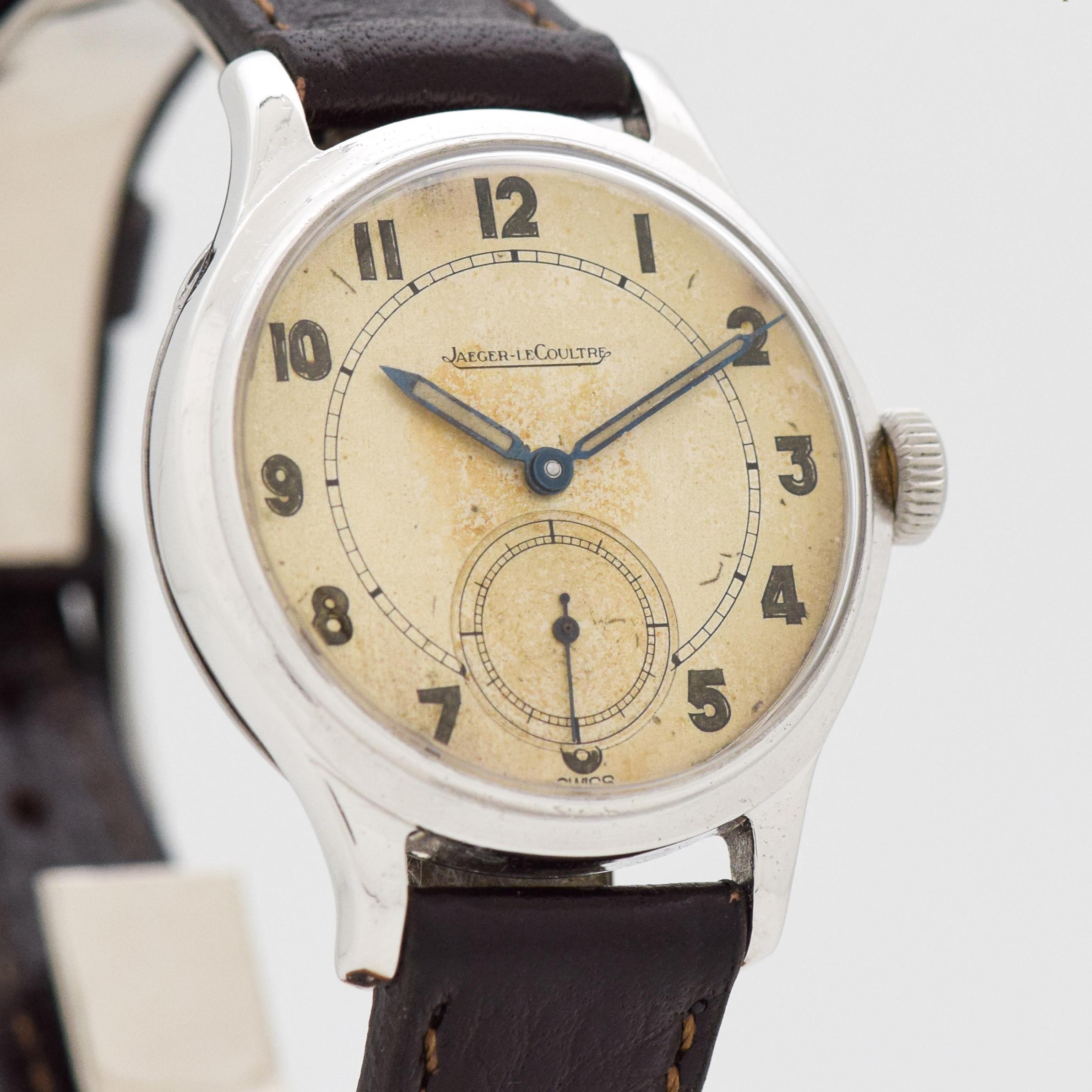 1940's - 1950's Vintage Jaeger-Le Coultre Stainless Steel watch with Original Patina Silver Dial with Gold Color Luminous Arabic Numbers. 33mm x 40mm lug to lug (1.3 in. x 1.57 in.) - 15 jewel, manual caliber movement. Triple Signed.