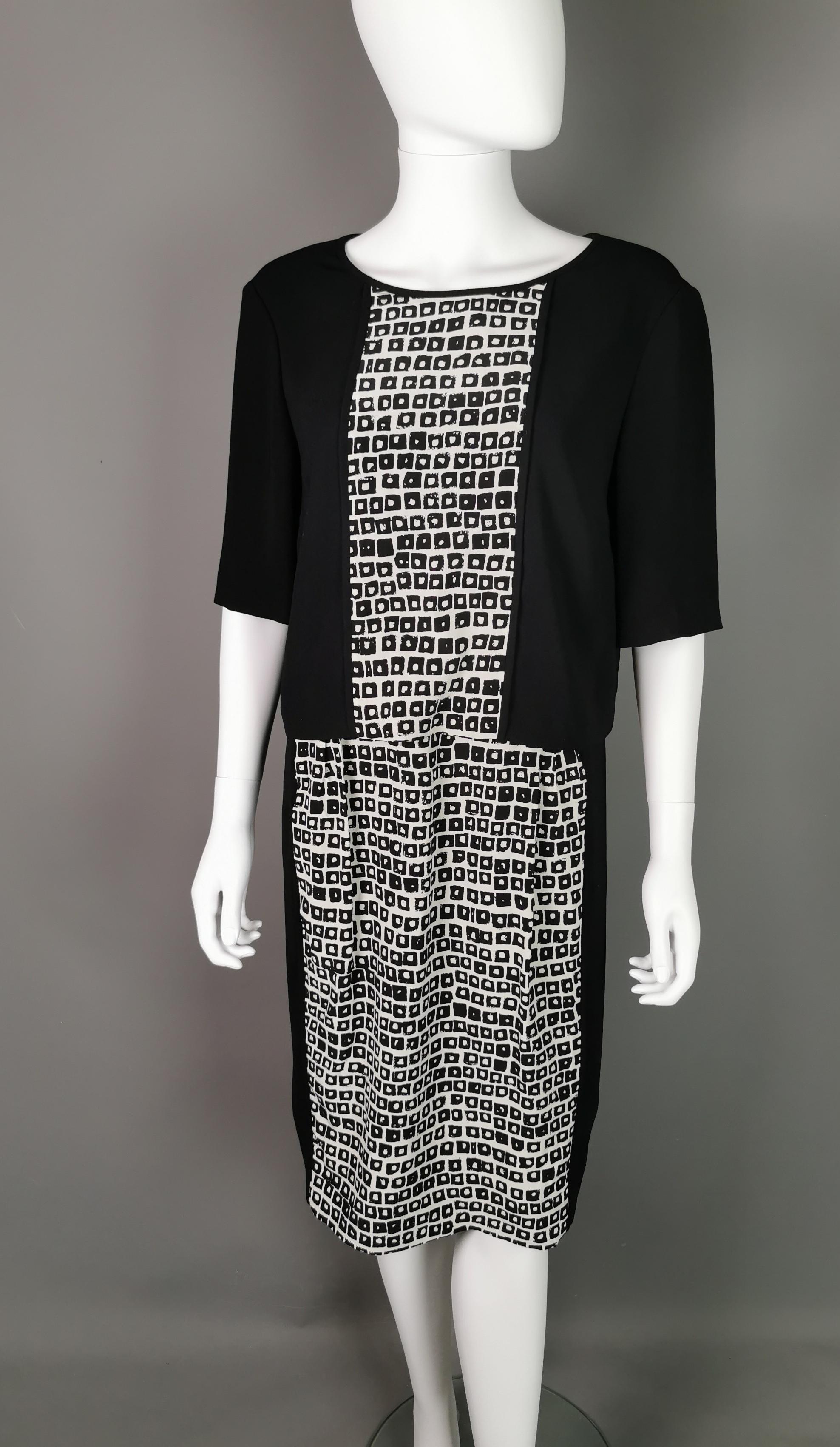 A stylish vintage Jaeger Monochrome silk sheath dress.

This is the perfect office / work dress with it's smart sheath silhouette and monochrome palette.

It has an abstract check pattern to the front of both the bodice and front and back of the