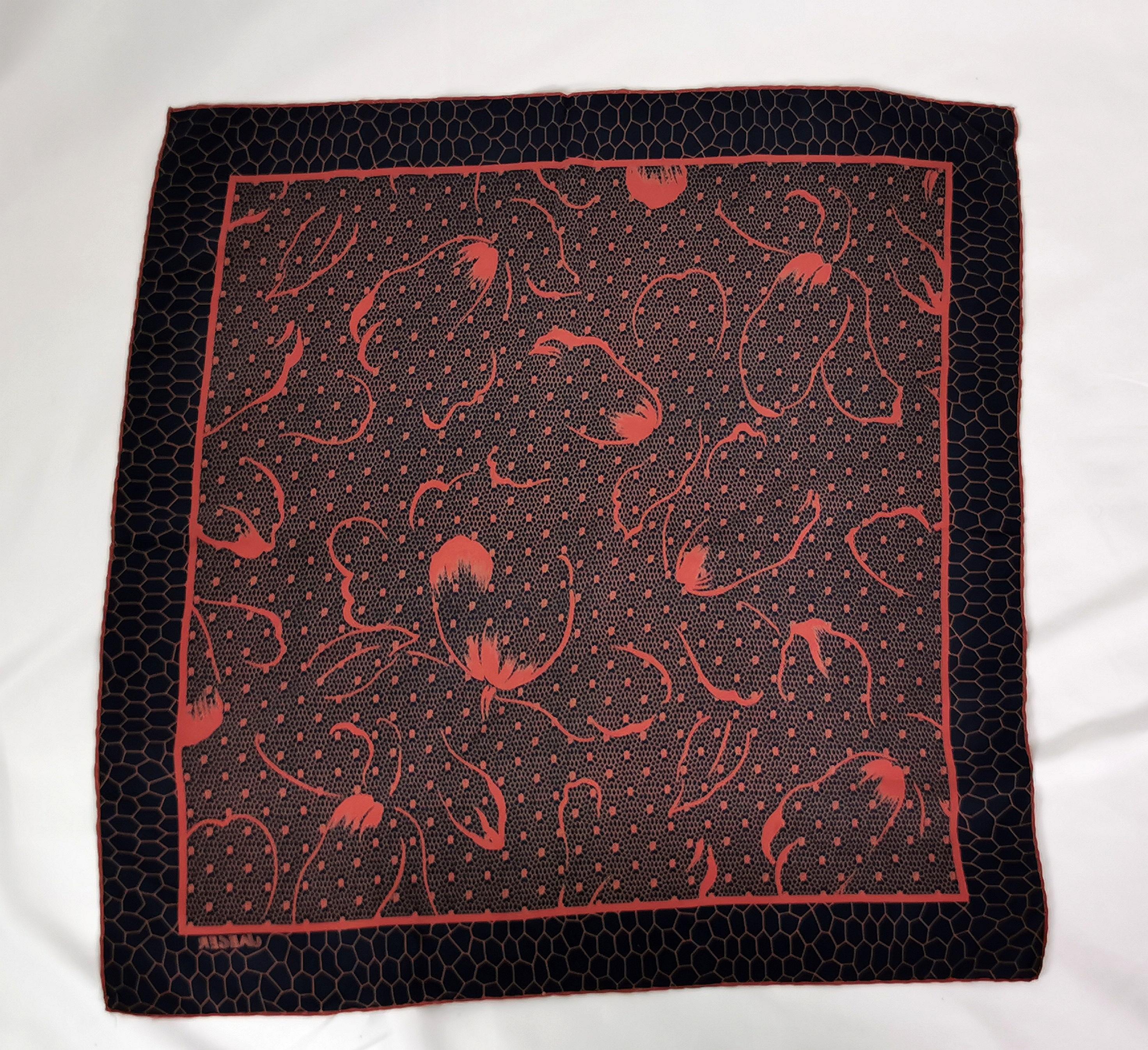 A very attractive vintage silk scarf by Jaeger.

It is a square shape, printed with a lovely abstract floral print in a rich warm orange on a deep navy blue ground.

A beautiful piece and versatile too, can be used in many ways and has a lovely