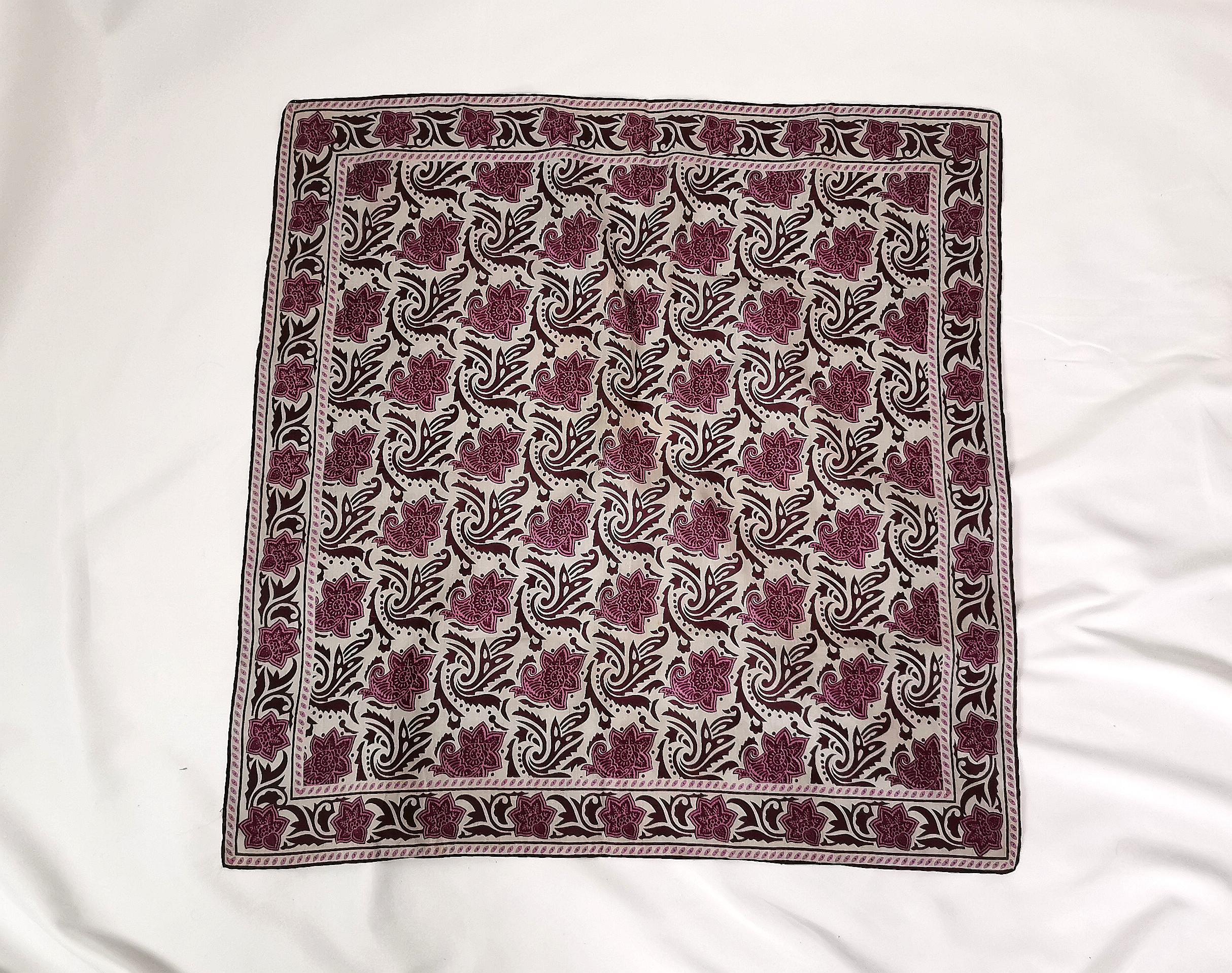 A very attractive vintage silk scarf by Jaeger.

It is a square shape, printed with a lovely abstract paisley print in rich colours of burgandy, magenta and cool off white.

A beautiful piece and versatile too, can be used in many ways and has a