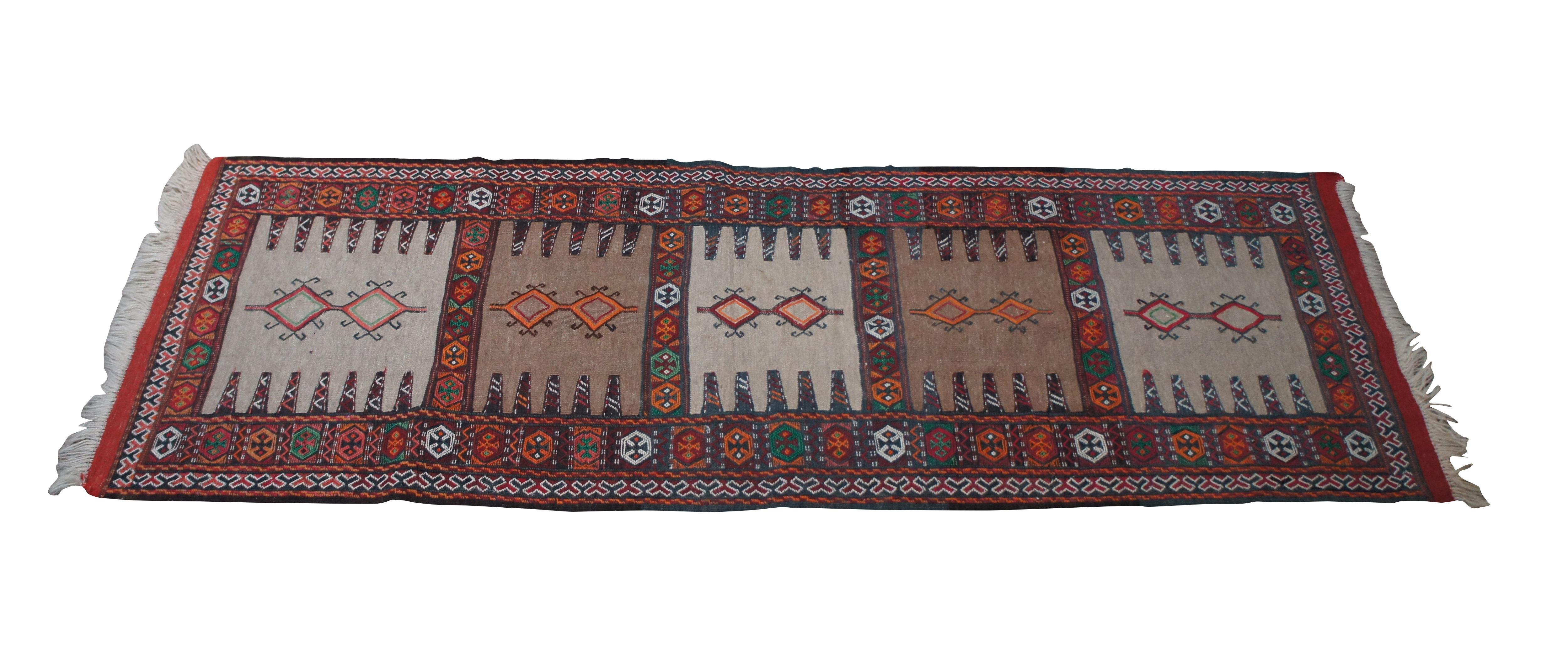Vintage Jajim Ghoochan hand woven rug runner featuring geometric design with reds, green, orange, blues, tans and white.  Made for Shiraz Rug Gallery of California.

74” x 25.5” / 2.2’ x 6.3’ (Length x Width)
