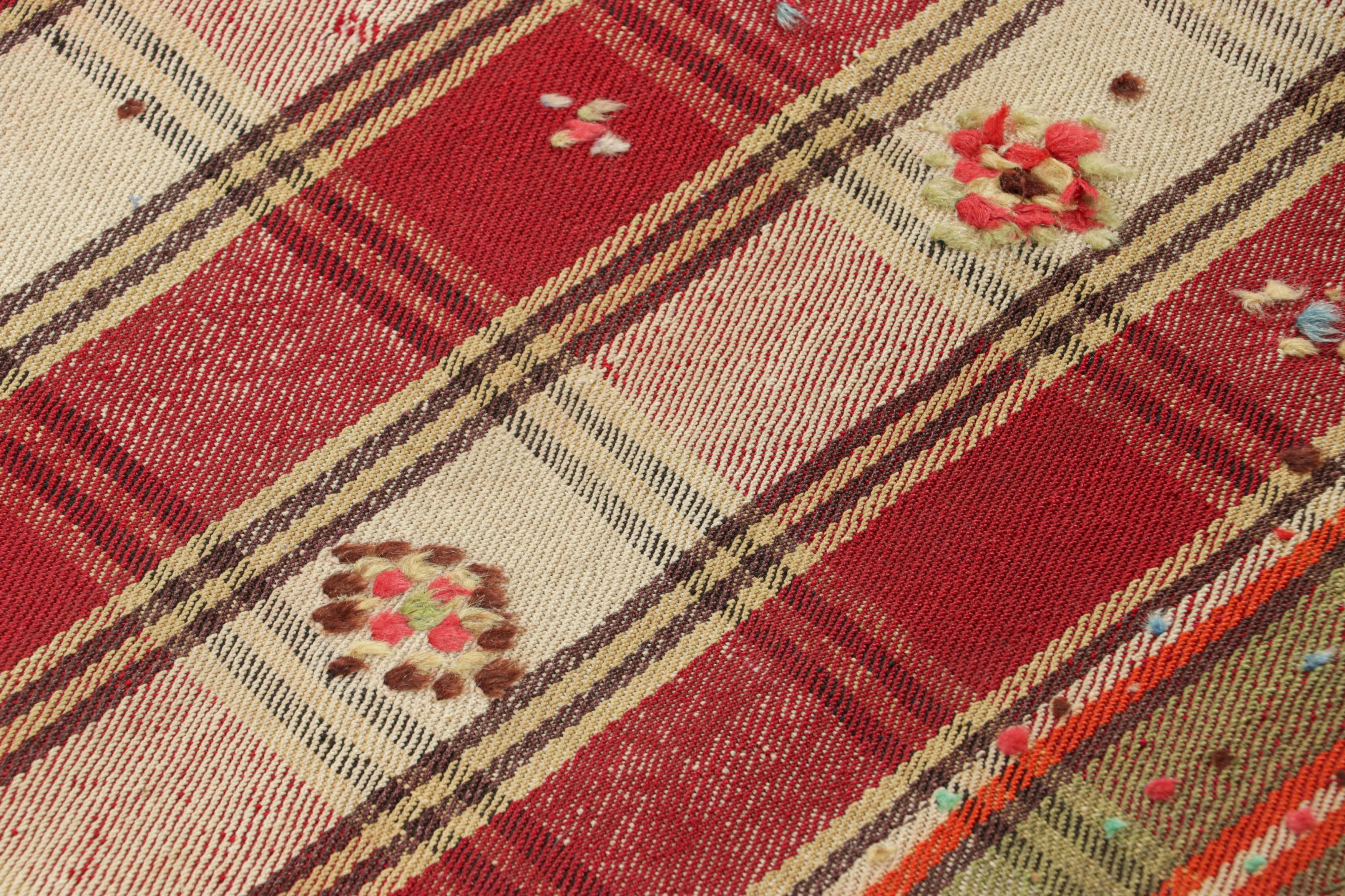 This vintage 5x8 Persian kilim is a mid-century Qashqai tribal rug, handwoven in wool circa 1950-1960.

On the Design: 

The mid-century Persian kilim features a vibrant plaid design dominated by alternating fields of deep red, green, and creamy