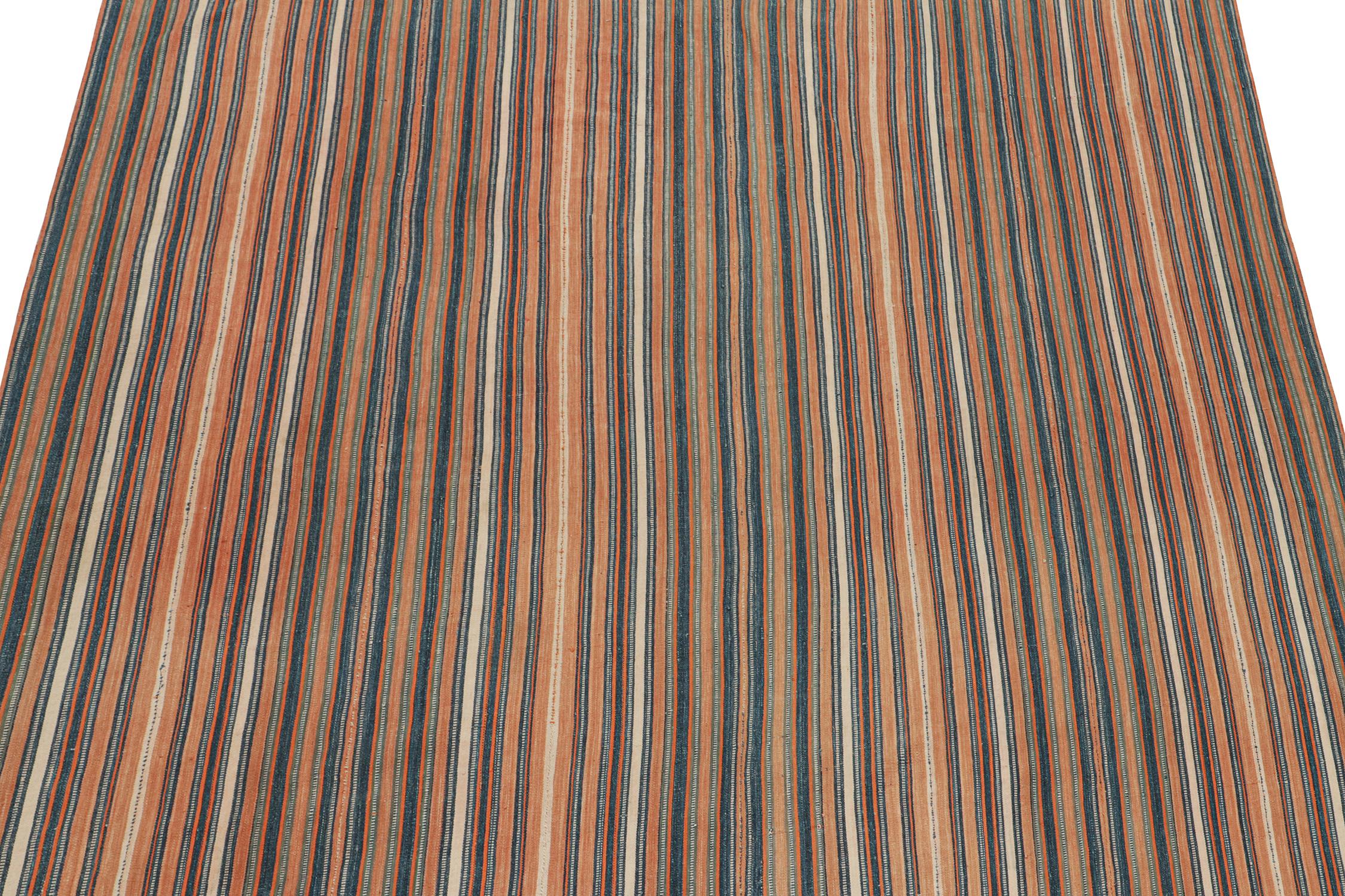 This vintage 6x6 Persian Kilim is a Jajim-style flat weave believed to originate from the Qashqai Tribe. 

Handwoven in wool circa 1950-1960, its design prefers navy blue and peach stripes with vibrant orange and off-white notes. Connoisseurs will