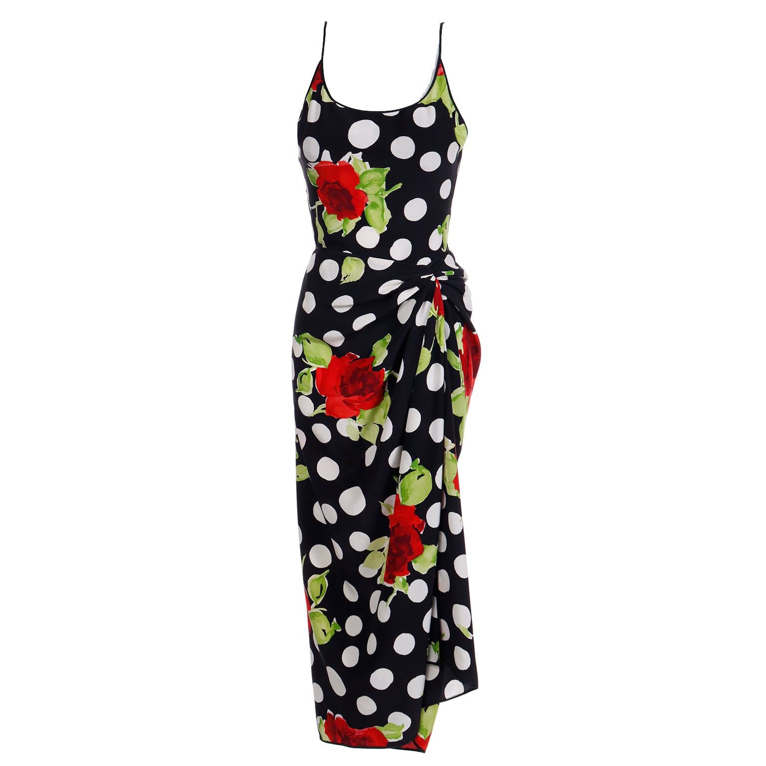 This is a gorgeous James Galanos vintage 2 piece silk outfit that includes a bodysuit and a wrap sarong style skirt. The print is a black and white polka dot with red roses and green leaves. The scoop neck one piece bodysuit has built in bra cups