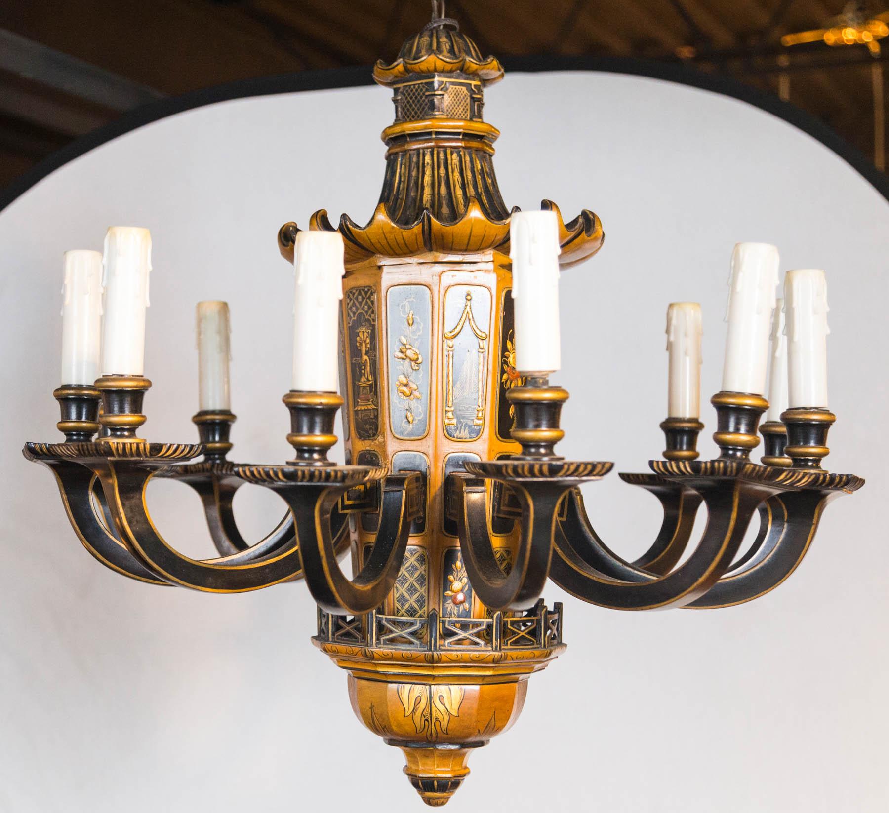 A 12-light French lacquered chandelier attributed to Maison Jansen, circa 1940s. Having rich raised hand painted and applied chinoiserie decoration on wood with an iconic pagoda form dome.