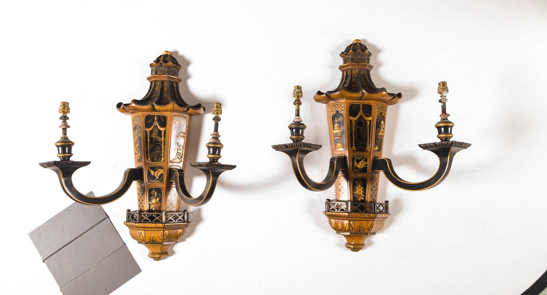 A large pair of French, circa 1940s lacquered wood hand decorated chinoiserie sconces attributed to Maison Jansen. Rich raised hand painted and applied decoration measuring a large 23