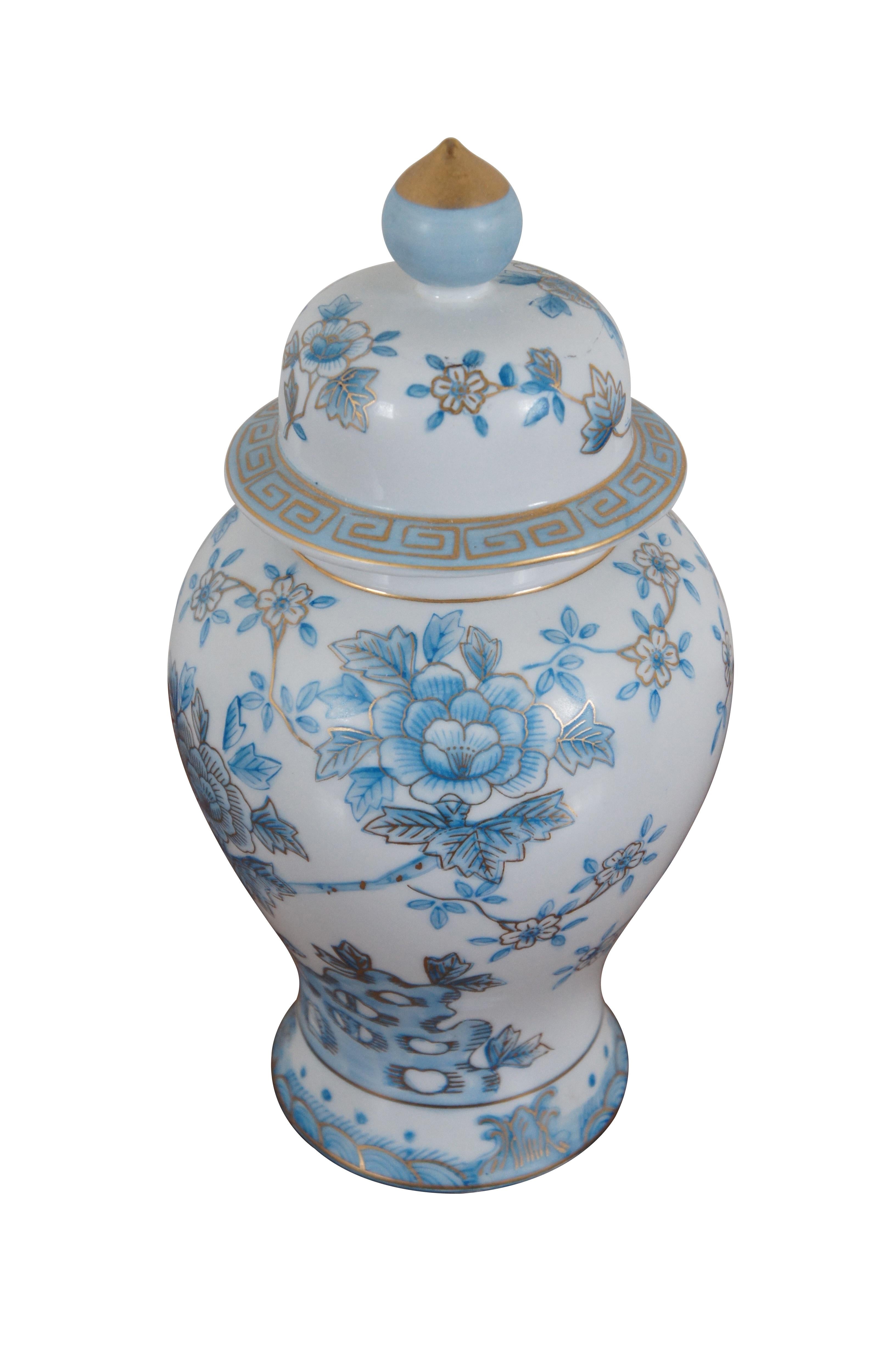 Vintage blue and white porcelain ginger jar / temple jar / lidded urn decorated with an array of flowers and branches with gilded details. Made in Japan. Marked with a gold triangle.

Dimensions:
6.25