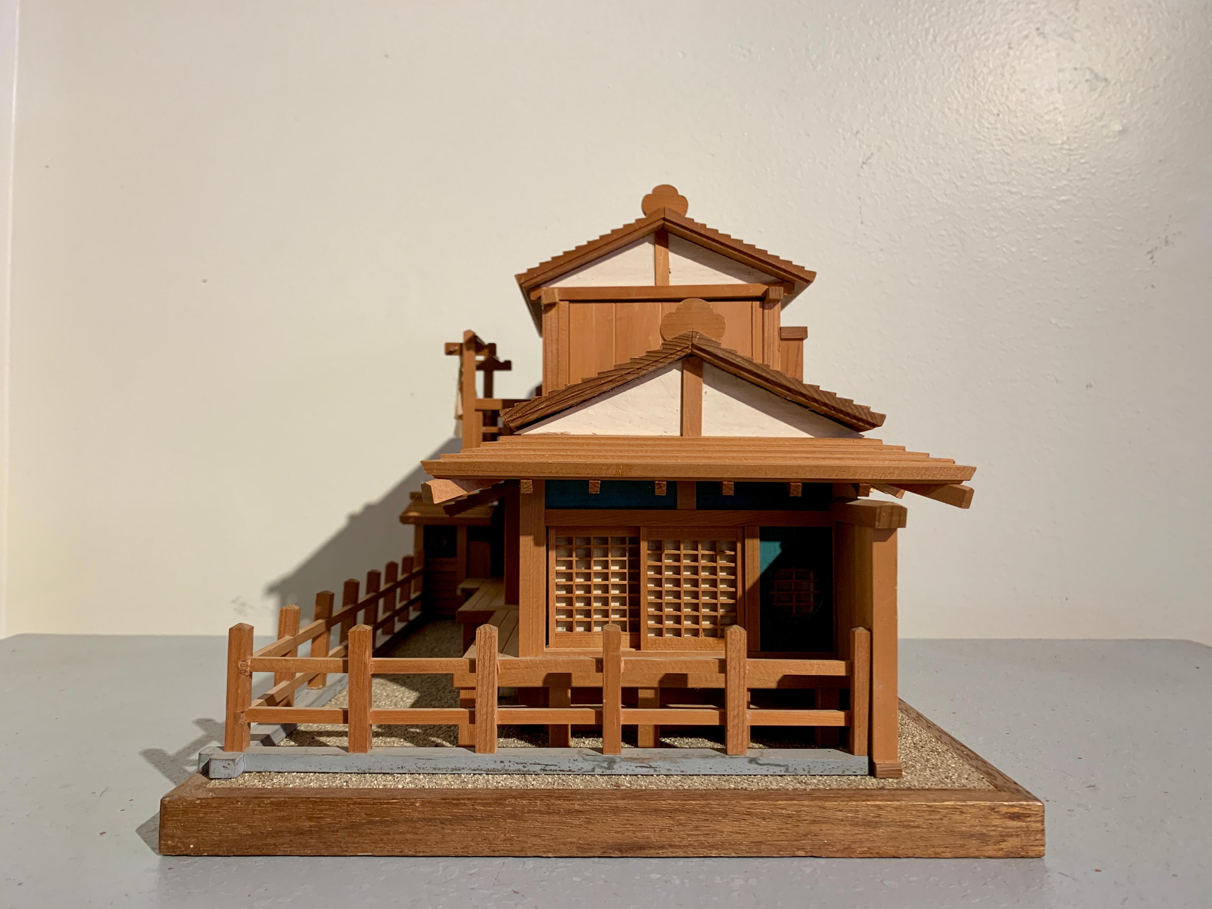 A delightful vintage wooden model of a traditional Japanese home, mid 20th century, circa 1950's, Japan.

The architectural model depicts a traditional Japanese home, with removable roofs, papered shoji doors, and a fenced yard. The two roofs are