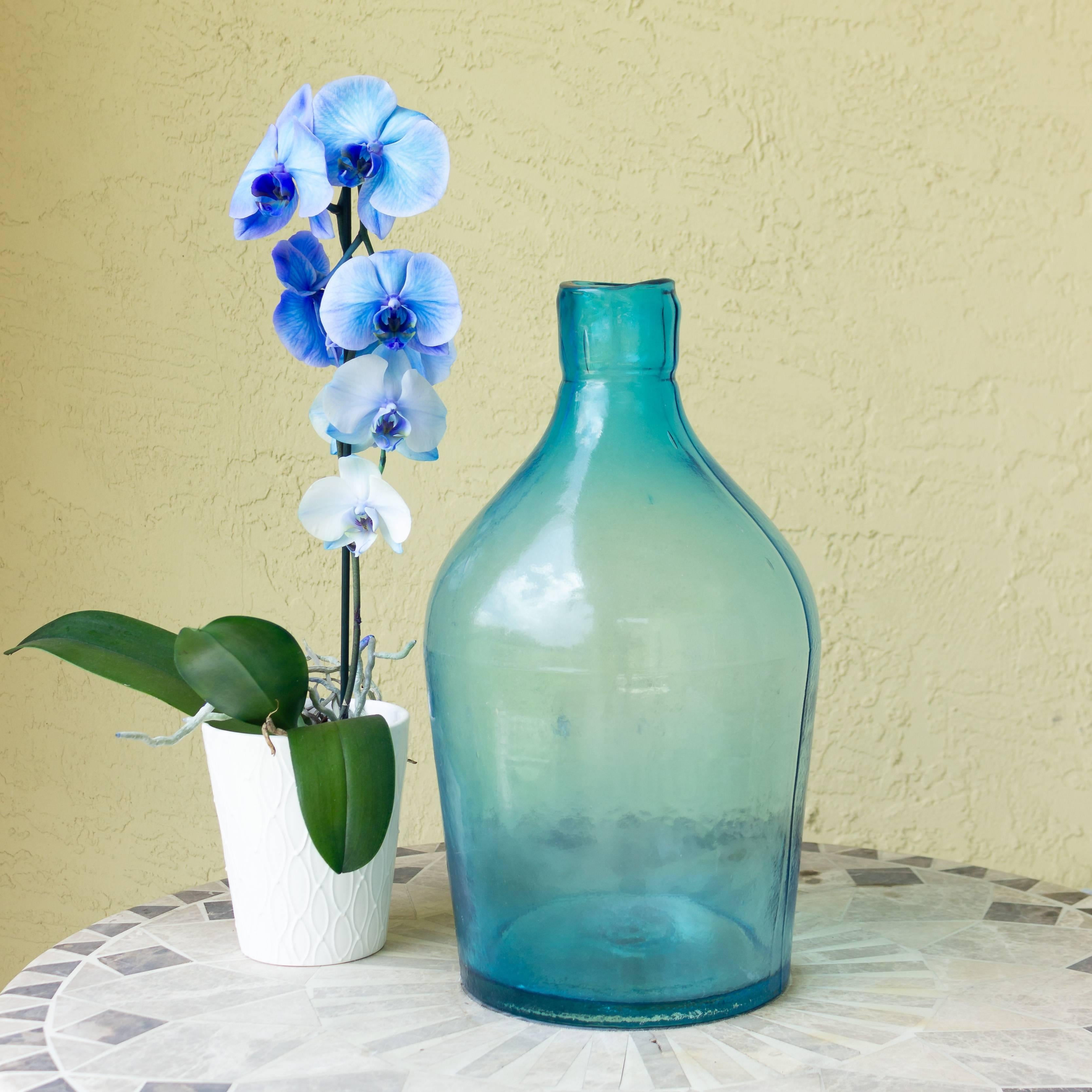 Two handblown blue glass bottles. Originally used for fishing and boating in Japan with a rope netting which has been removed. Two similar pieces of glass with the original rope netting are available.

The larger piece measures 17