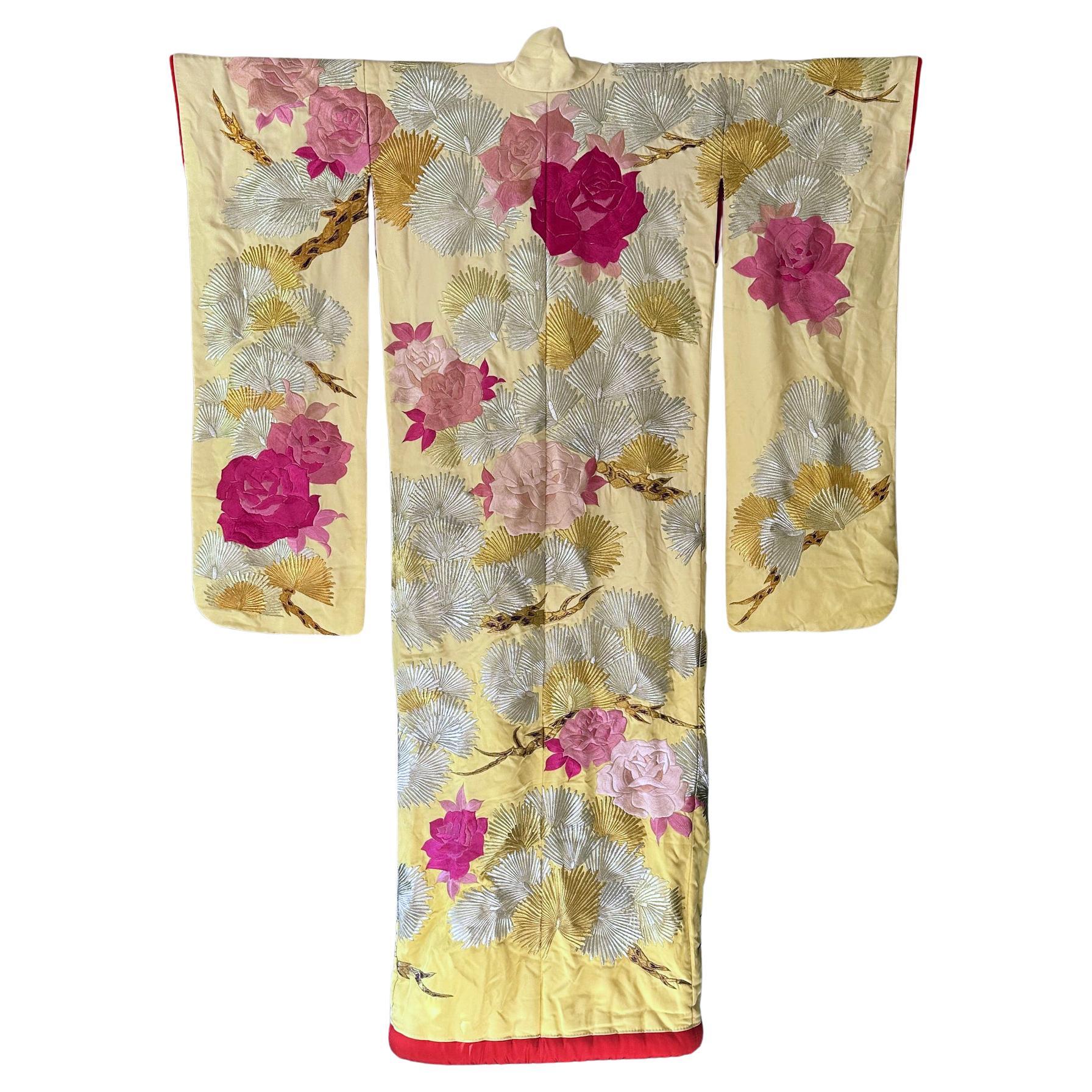 A large Japanese Wedding Kimono with bold embroidery designs. The auspicious attire was known as Uchikake and was worn by the bride during the wedding ceremony made from silk and heavy padding on the trailing skirt. The robe on offer has a