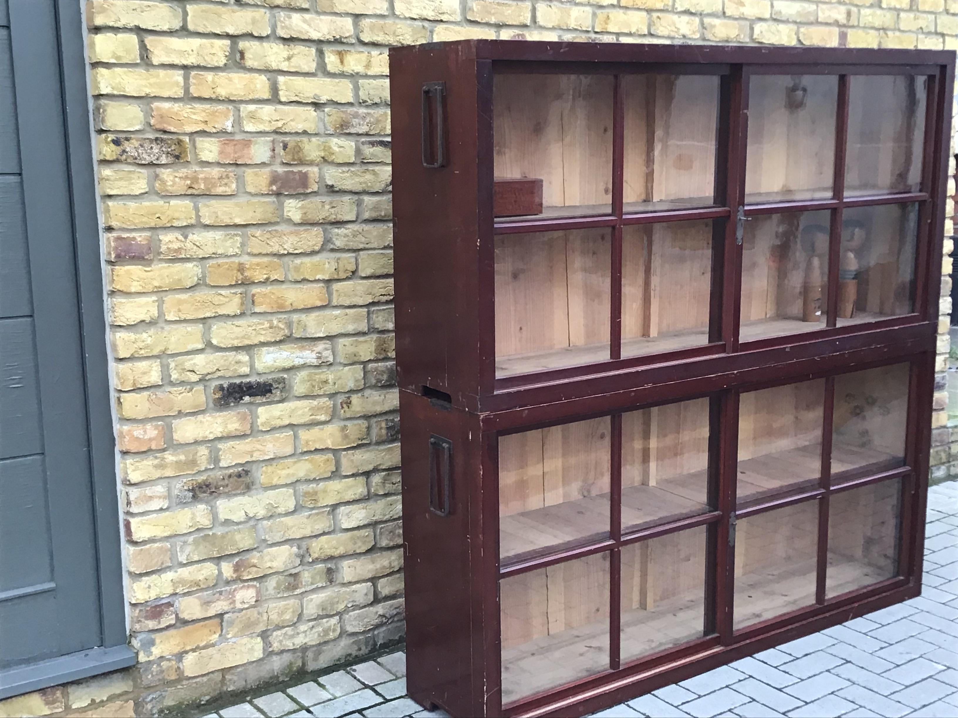 Two-part display cabinet in painted wood with glass fronted lockable sliding doors and shelves, circa 1960s, Japanese.