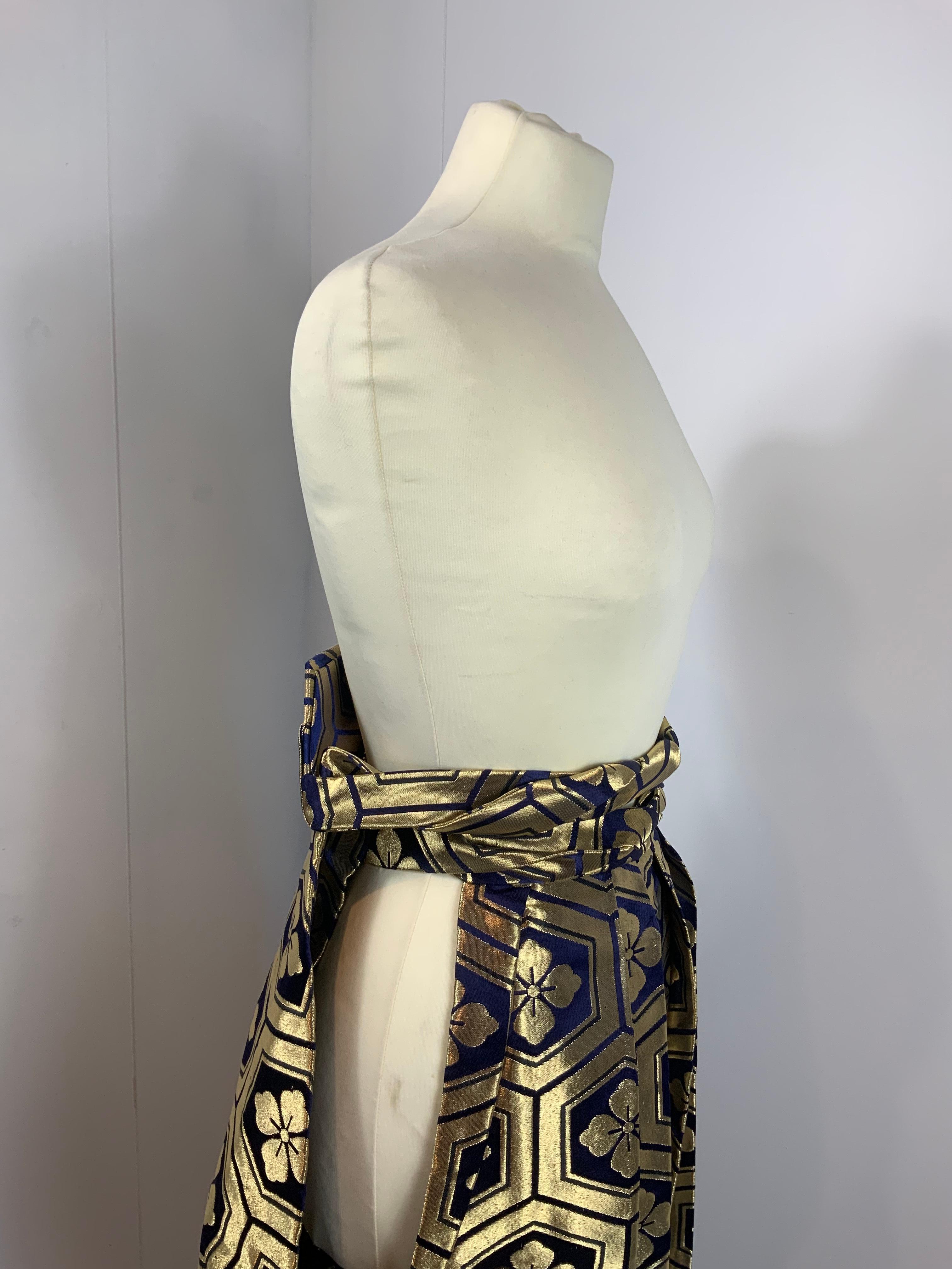 Vintage Japanese Hakama. 
Featuring a very nice blue and gold jacquard pattern. Synthetic fabric.
Traditional Japanese trousers. Bought in Kyoto.
One size. Total length is 83 cm.
Conditions: Good - Previously owned and gently worn, with little signs