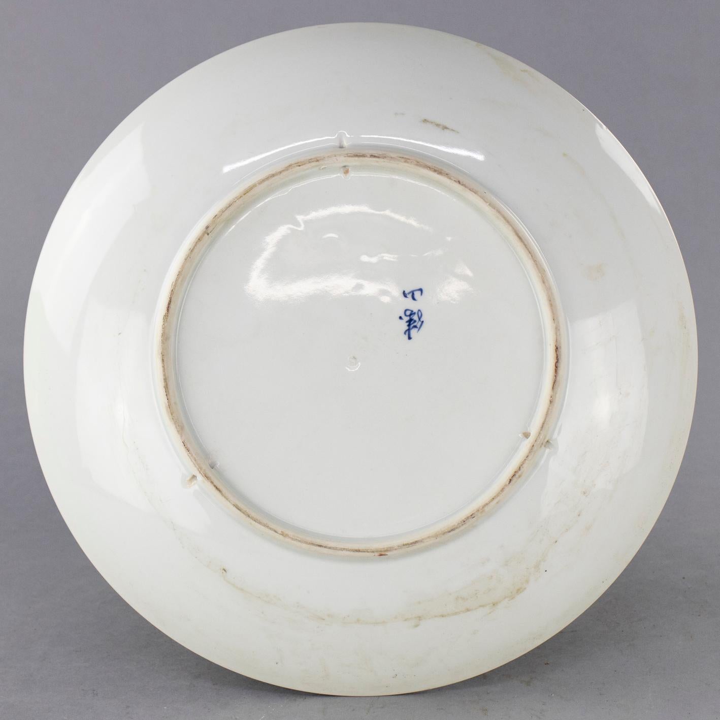 An antique Japanese Meiji Imari charger offers porcelain construction with hand painted and gilt stylized fan decoration, en verso signed as photographed, 20th century. 

Measures: 2