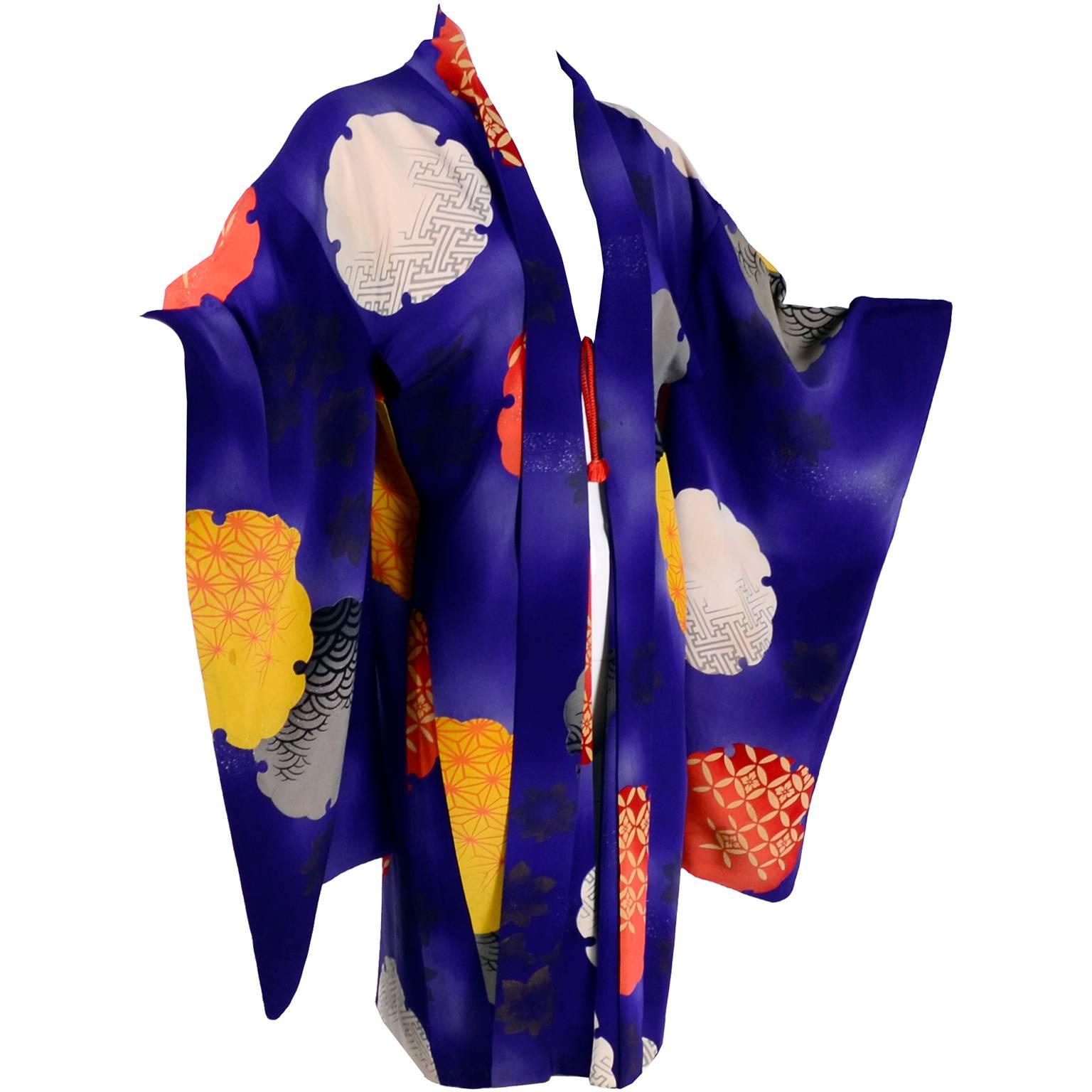This is a stunning 1930's vintage Haori style Japanese jacket in a lush purple silk with yellow, orange and ivory mon crests.  I've never seen one quite like this one with its bold colors and giant print! This came from an estate of antique and