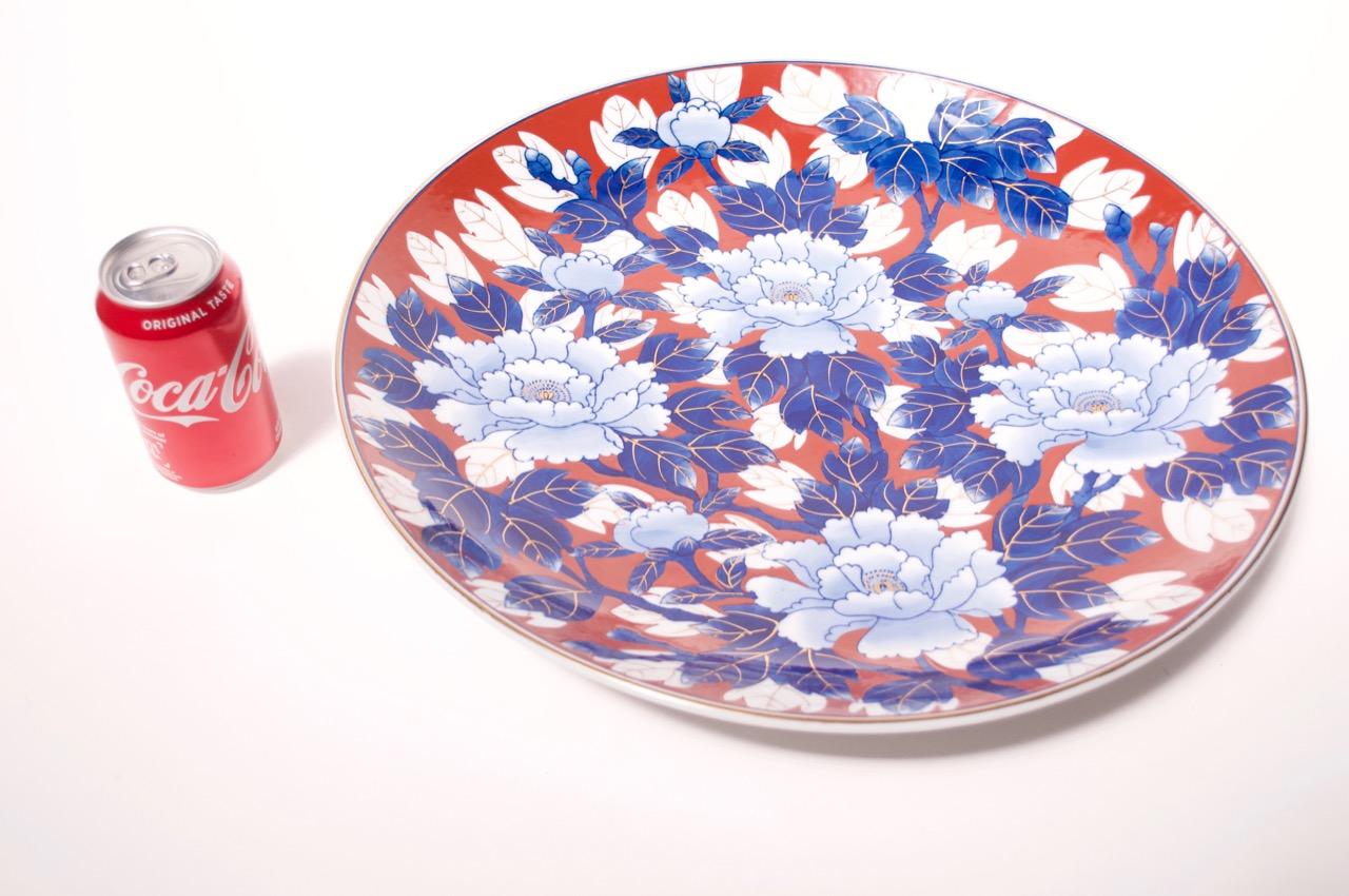 Japanese Imari decorative plate / charger featuring chrysanthemum pattern in red, white and blue with applied gilt detail, circa late 19th-early 20th century.
Large scale measuring 18.25