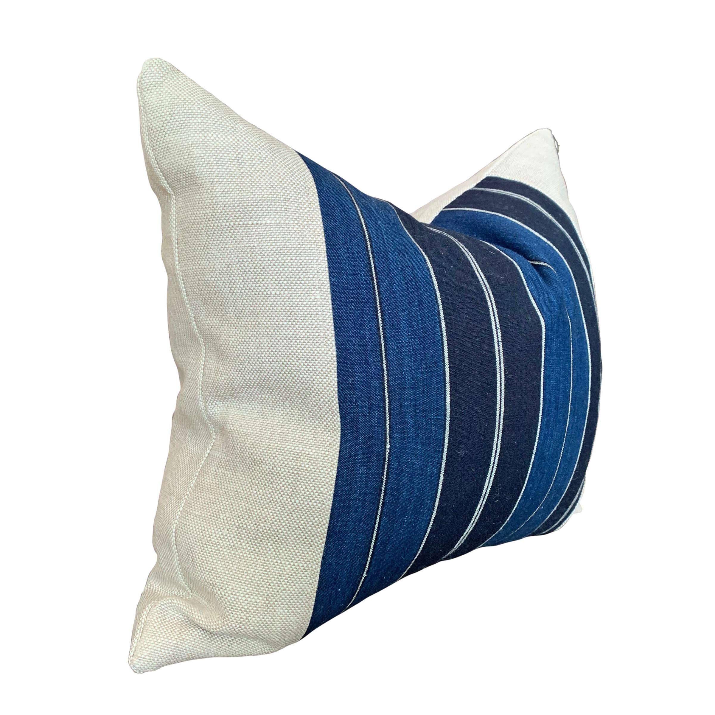A wonderful newly-made pillow constructed from a vintage Japanese striped indigo dyed panel, backed with linen, and filled with down.