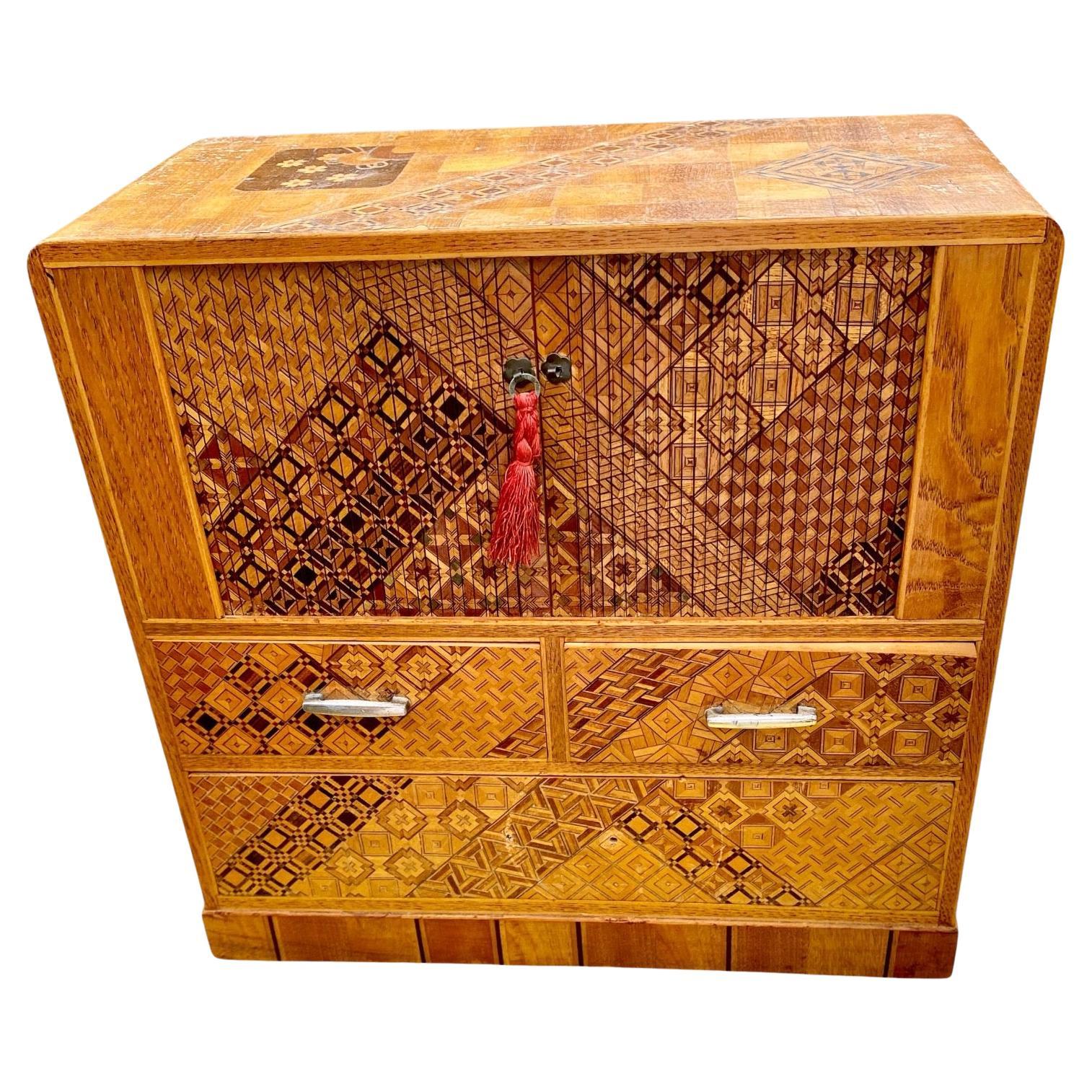 A fine, vintage Japanese Inlaid Marquetry Kodansu, Jewelry/miniature Chest with Tambour Doors in the Art Deco style, circa 1930.
This exquisite, handcrafted jewelry chest has intricate inlaid marquetry designs in mahogany, fruitwood, ebony, elm,