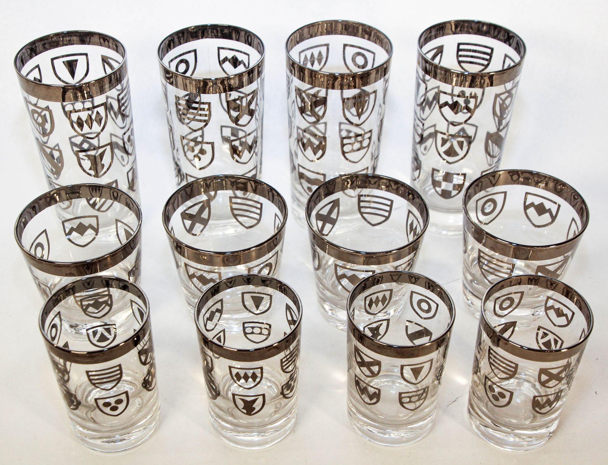 Vintage Japnese Kimiko Style Silver Cocktail Glasses Set of 12.
Vintage Set of 12 Kimiko style glasses from the 1960s, featuring a silver band and a shield crest accent.
Set of 12 Vintage Mid-Century Kimiko highball glasses and shot glasses.
This