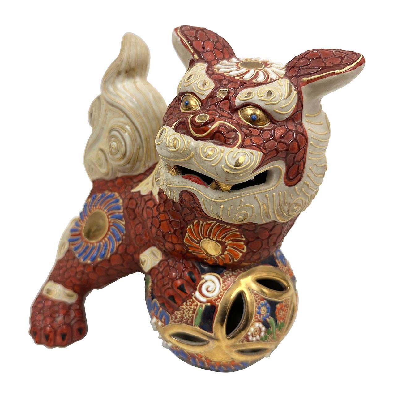 

Fabulous colorful hand painted porcelain foo dogs from Japan feature a ornate decoration on the body with colorful accents and gold detailing. Crafted by Kutani in Japan, the detailed carving works shows this happy foo dog is playing with ball.