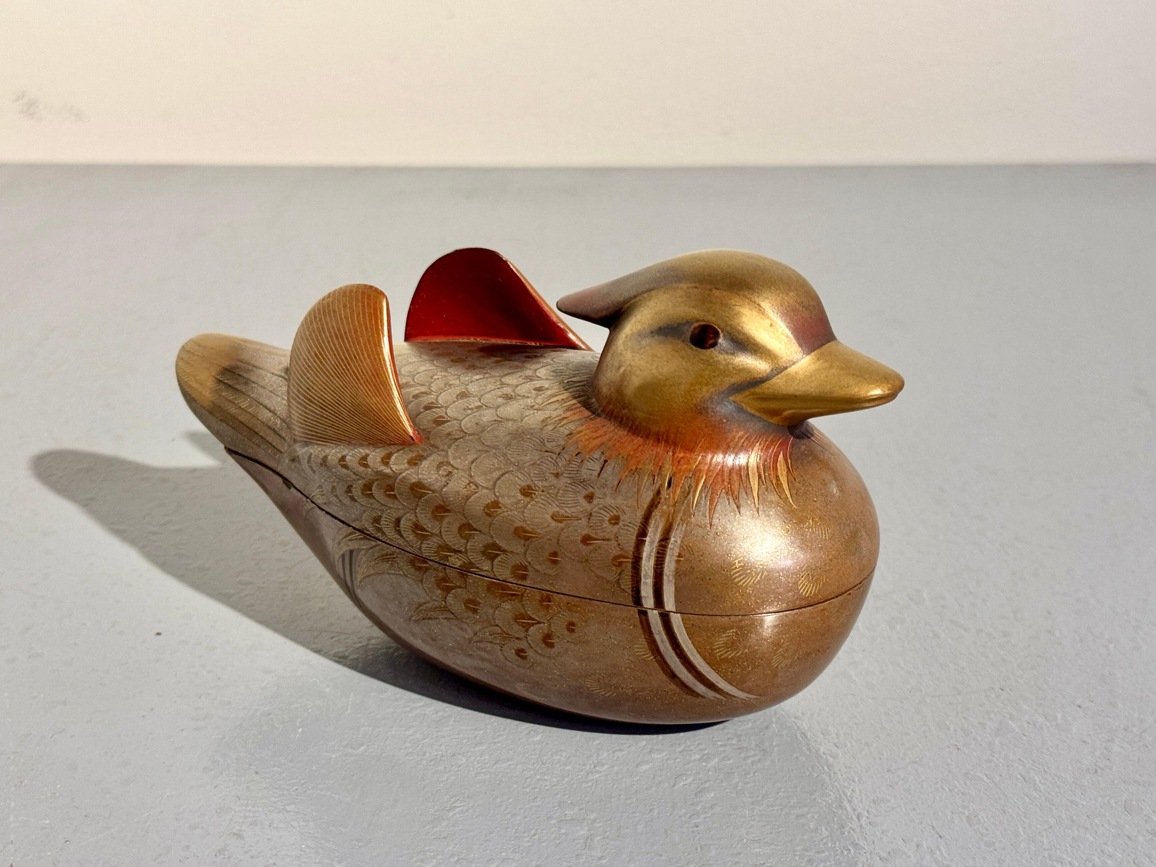 A finely decorated vintage Japanese box for precious incense, kogo, in the shape of a male mandarin duck, oshidori, by Zohiko, Showa Era, 1960's, or earlier. 

The lovely and whimsical box formed as a male oshidori, mandarin duck. The duck is