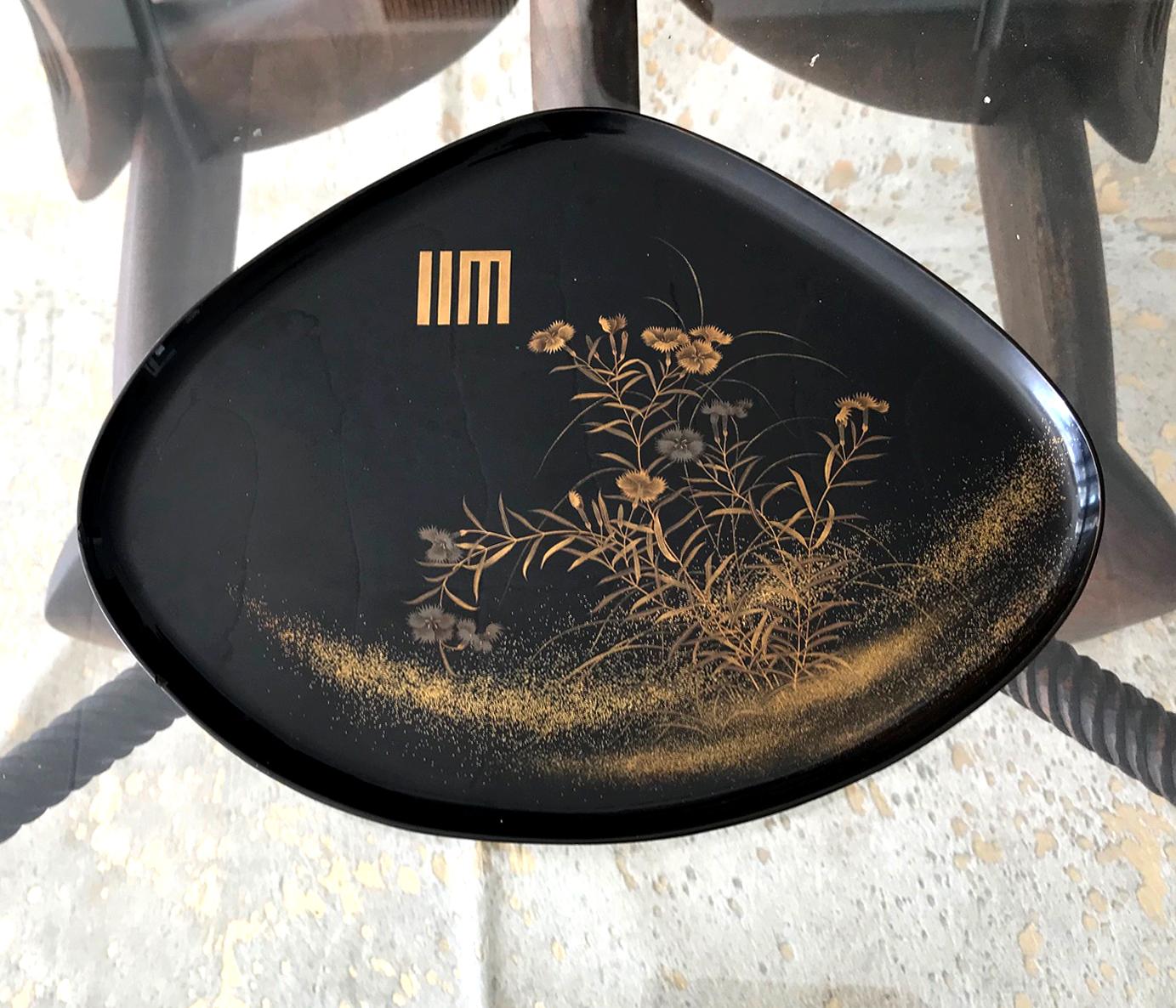 A fan shape black lacquer tray from Japan circa 1910-30s, late Meiji to early Showa era. Elaborated decorated with a bundle of yomogi blossom in a very fine Maki-e technique using both gold and silver powders. There is a Japanese symbol on the top