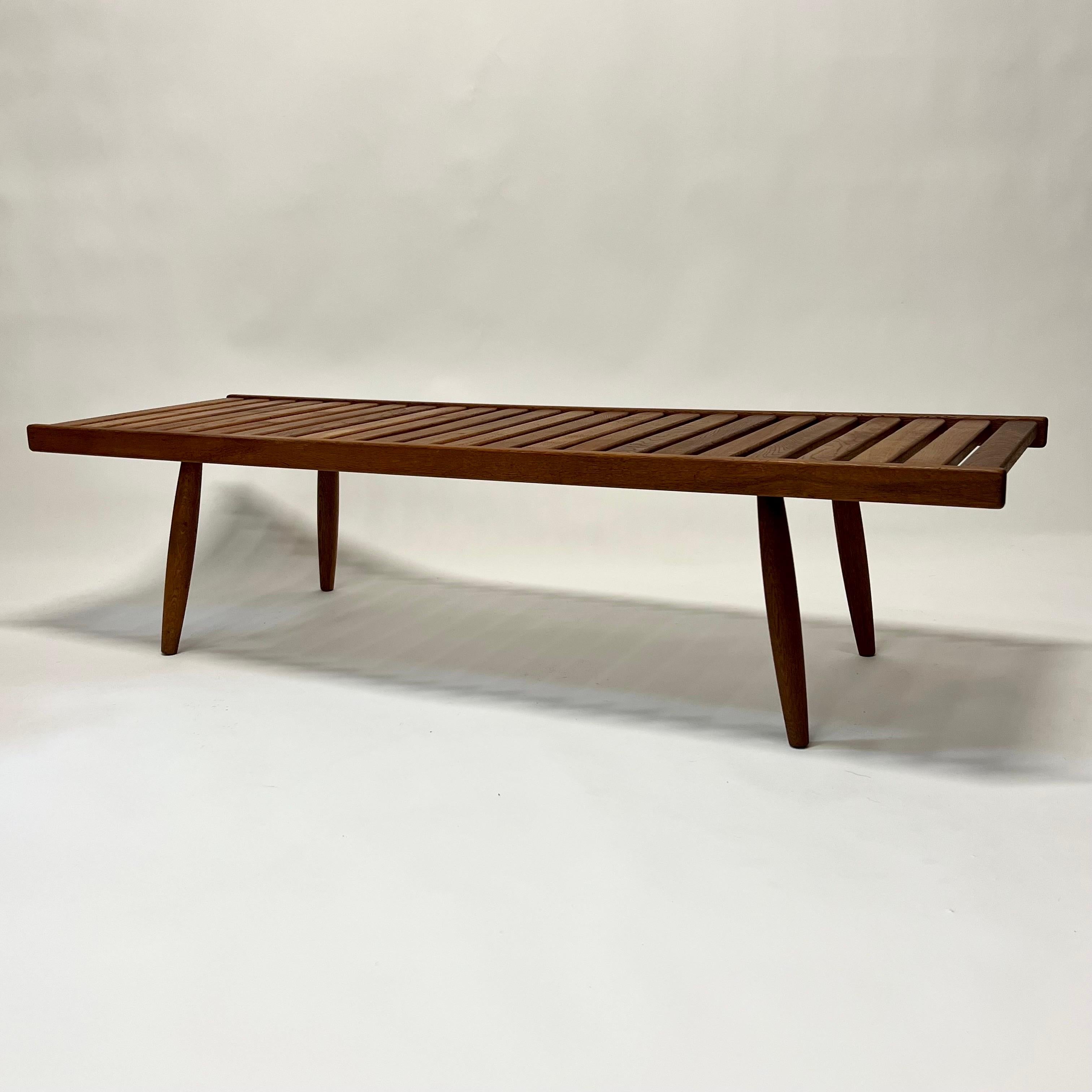 Stunning Mid-Century Modernist slat coffee table manufactured by AFM circa 1960s, Japan. Clean lines, beautiful patinated oak with double tapered sculpted legs.