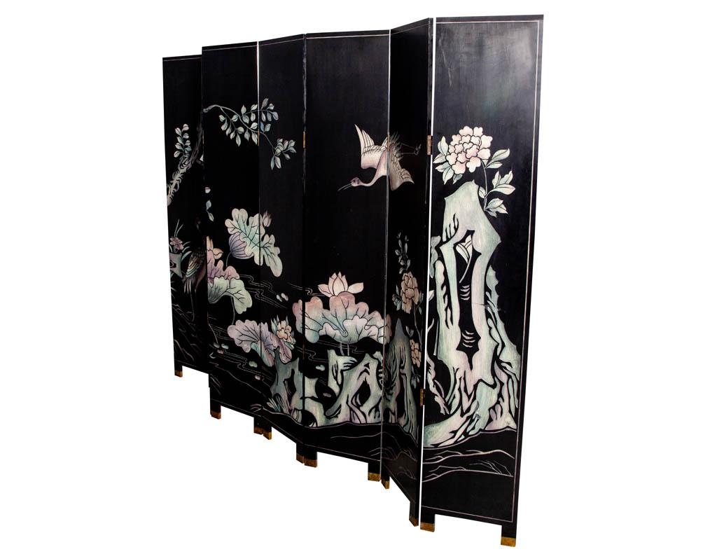 Vintage oriental screen room divider with crane, pagoda and floral hand painted motifs. Japanese cranes are among the rarest cranes in the world and are symbols of fortune, longevity, and loyalty in the Japanese culture. The screen also features a