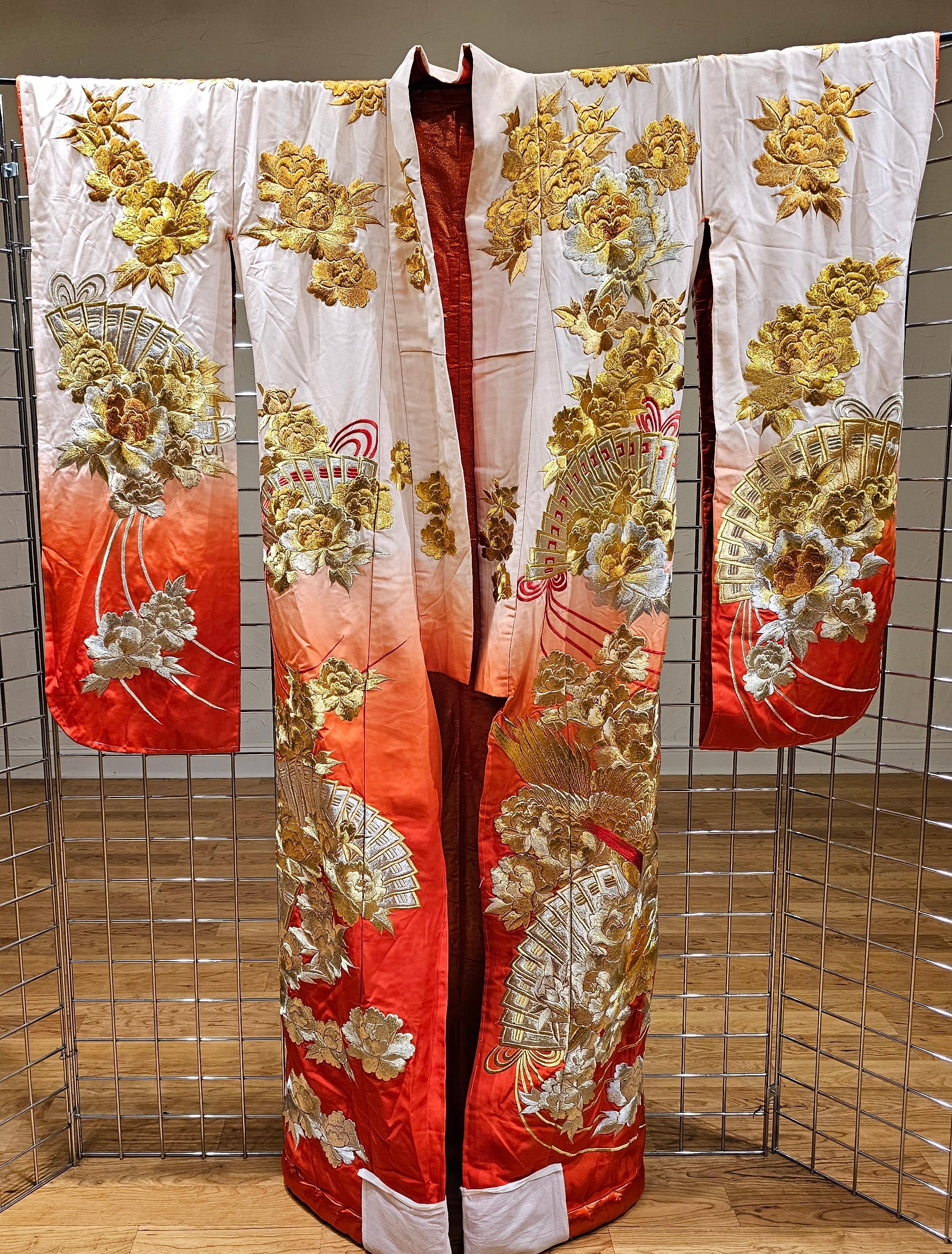 Visually striking vintage Uchikake Wedding Kimono/Robe for ceremonial occasion, circa end of Meiji to Taisho period 1910s-1930s. This bridal outer garment is of a white and  red color that features elaborate and intricate embroidery in gold and red