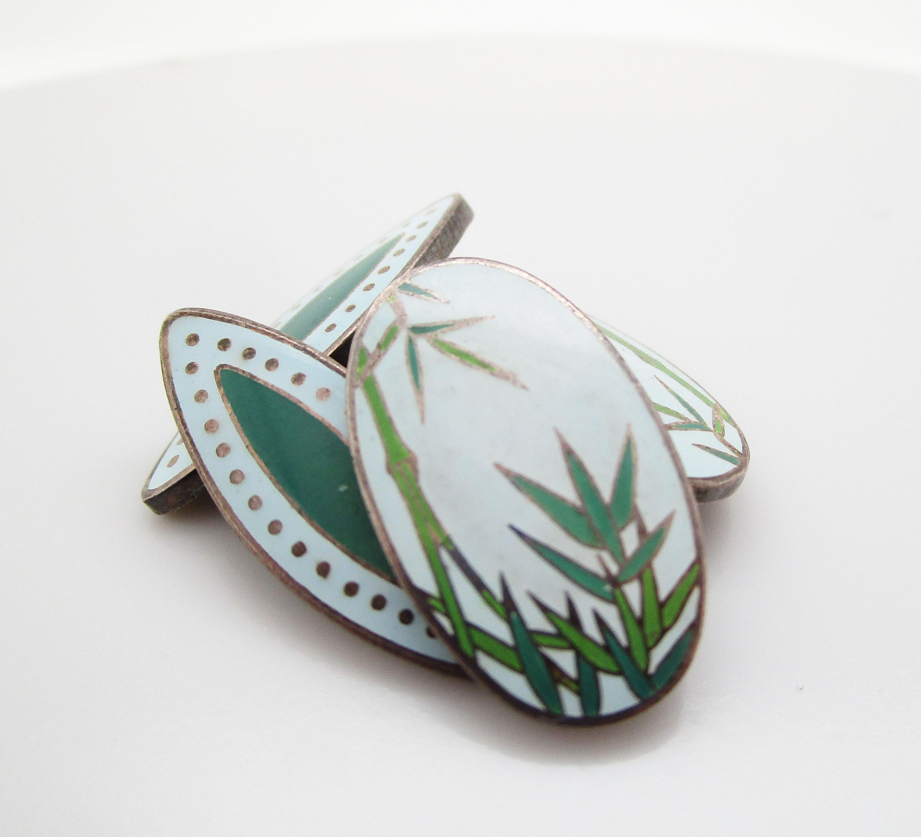 This is an excellent pair of vintage Japanese sterling silver enamel cufflinks with an elegant bamboo pattern. The enamel is in excellent shape and features several shades of green, as well as a soft minty blue shade as the base of the panels. The