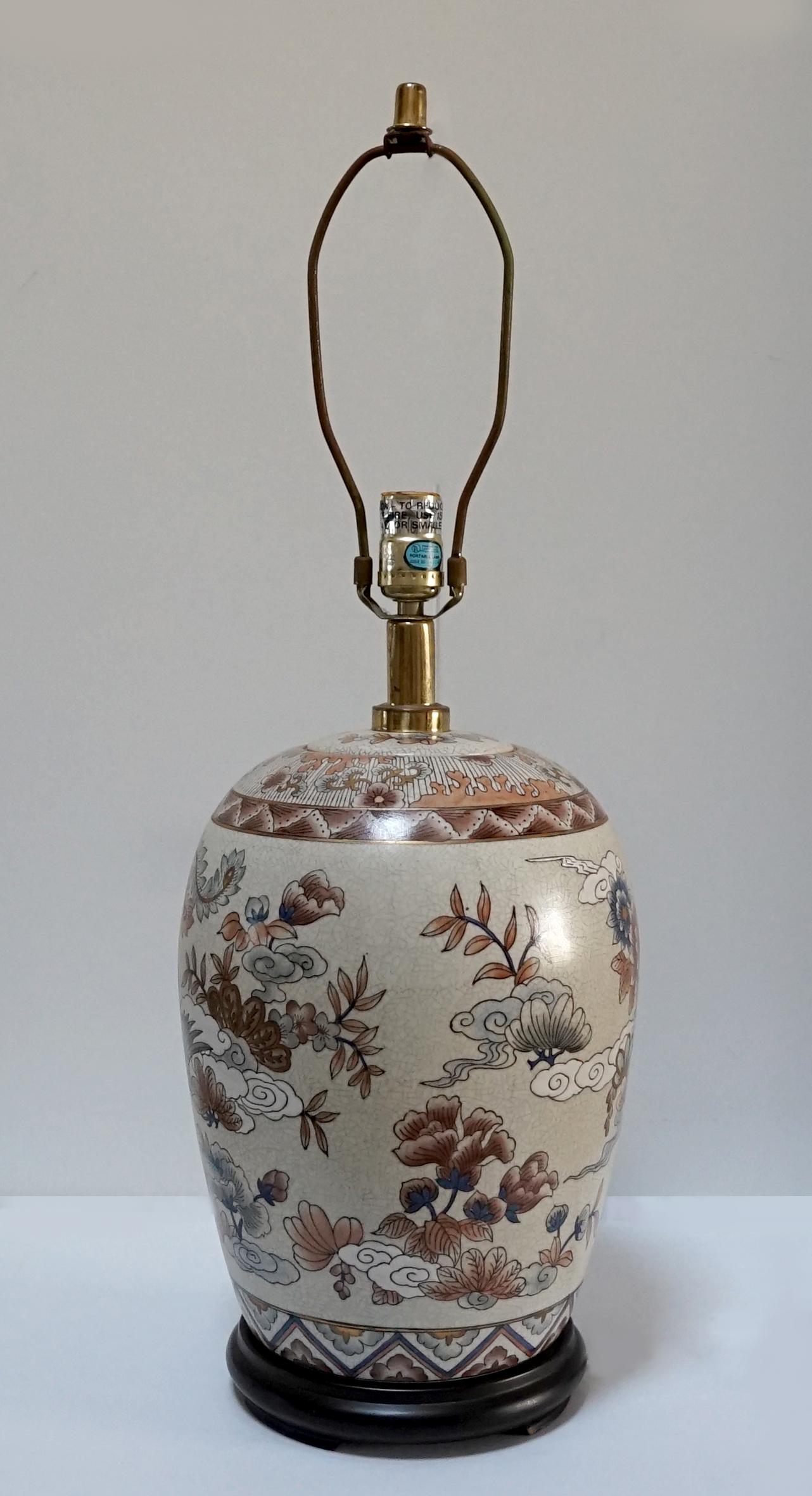 Two geometric bands at the top and near the base of this lamp form an accent for the beautiful profusion of clouds and birds in flight on the background of this lamp. The dominant colors are muted, tan, beige, brown and sky blue. The condition of