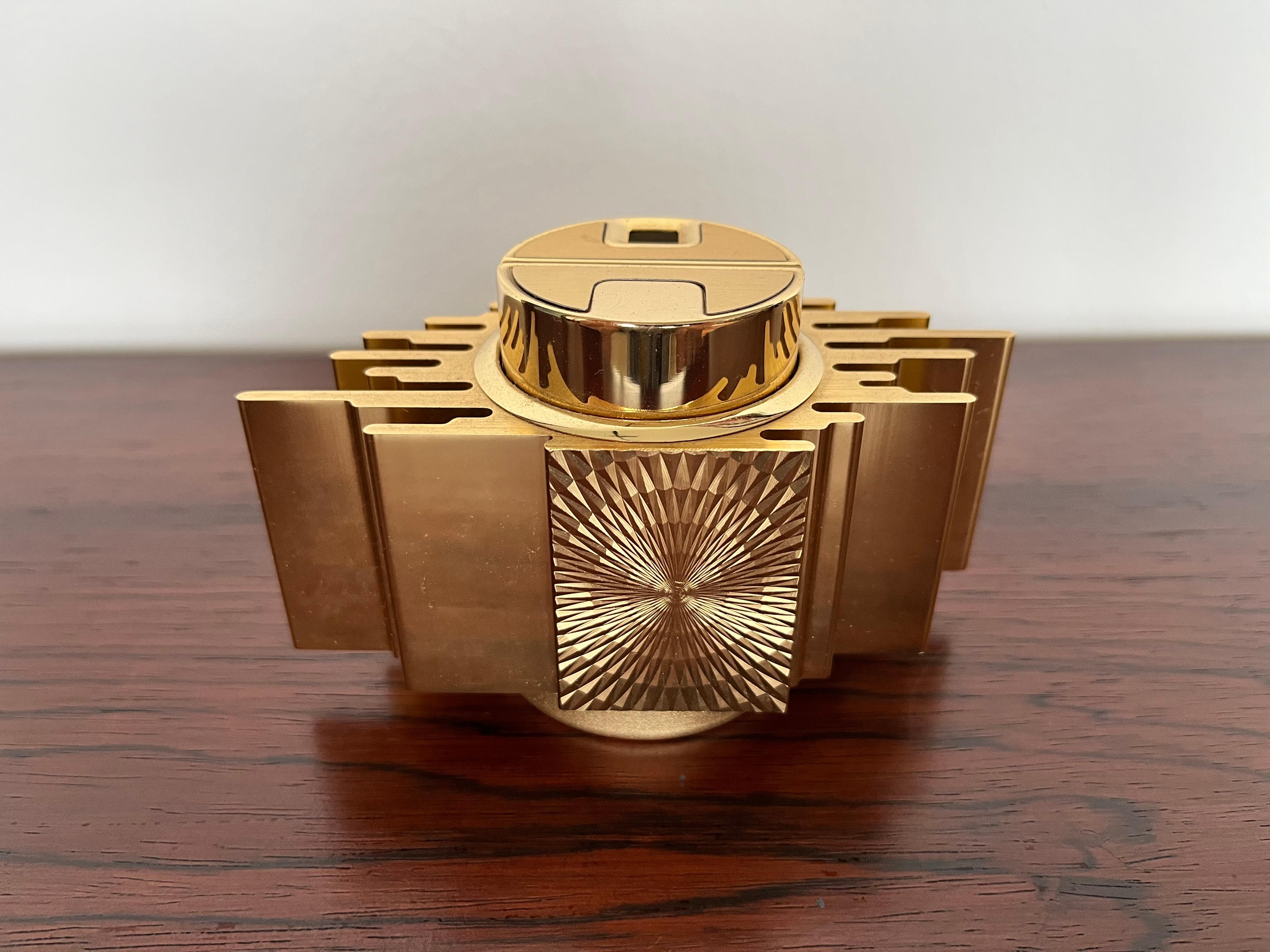 A 20th century table lighter manufactured by Japanese Sarome circa 1960s design in Art Deco style gold graphic shape. An interesting decorative piece for table decor. Working condition with original label.