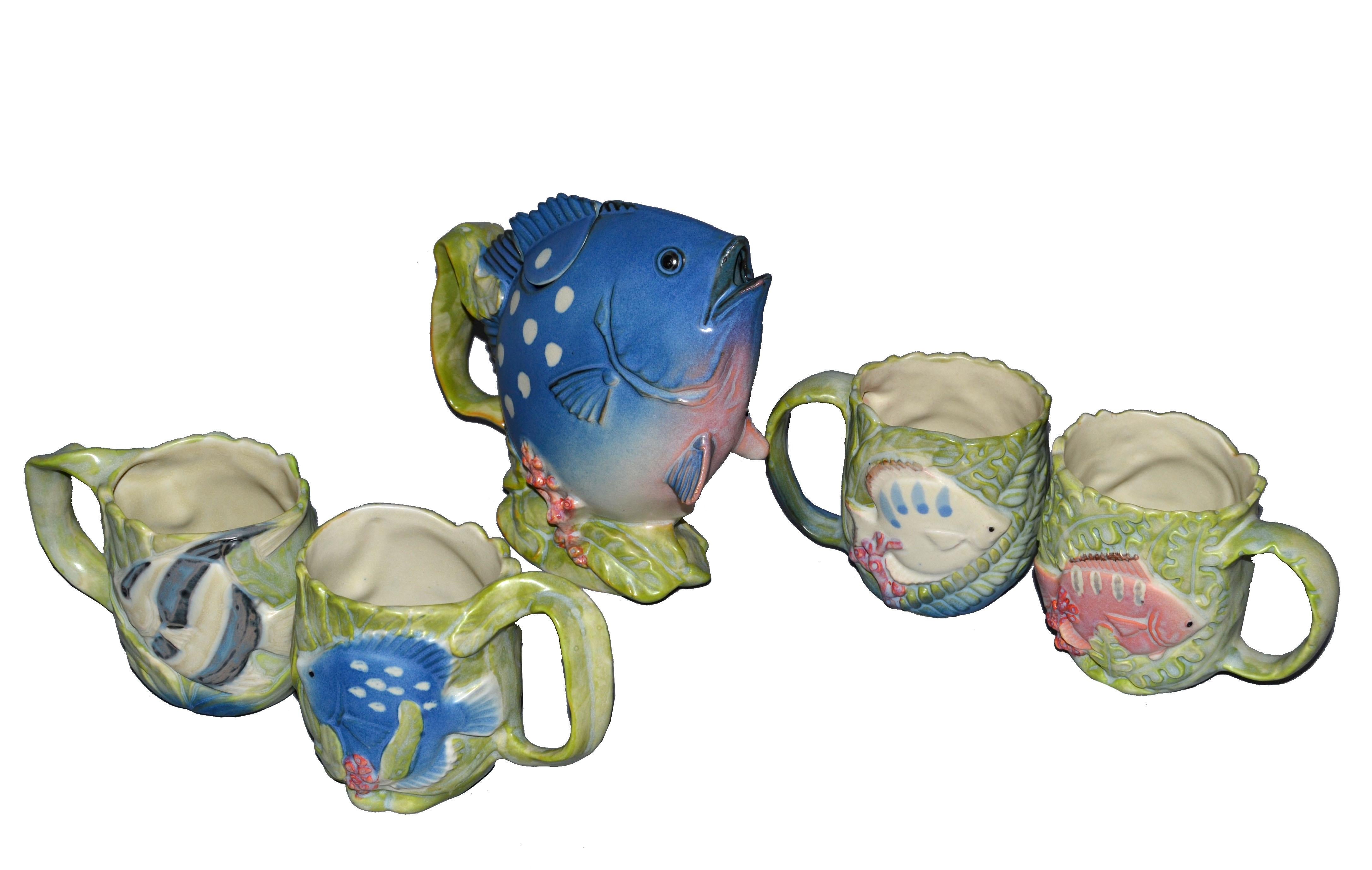 5 pieces pottery tea set vintage Japanese Takahashi San Francisco California.
Hand painted fish form teapot and four tea cups or mugs with a fish on each side.
Each cup or mug has two different colored fish motives in relief.
All pieces are