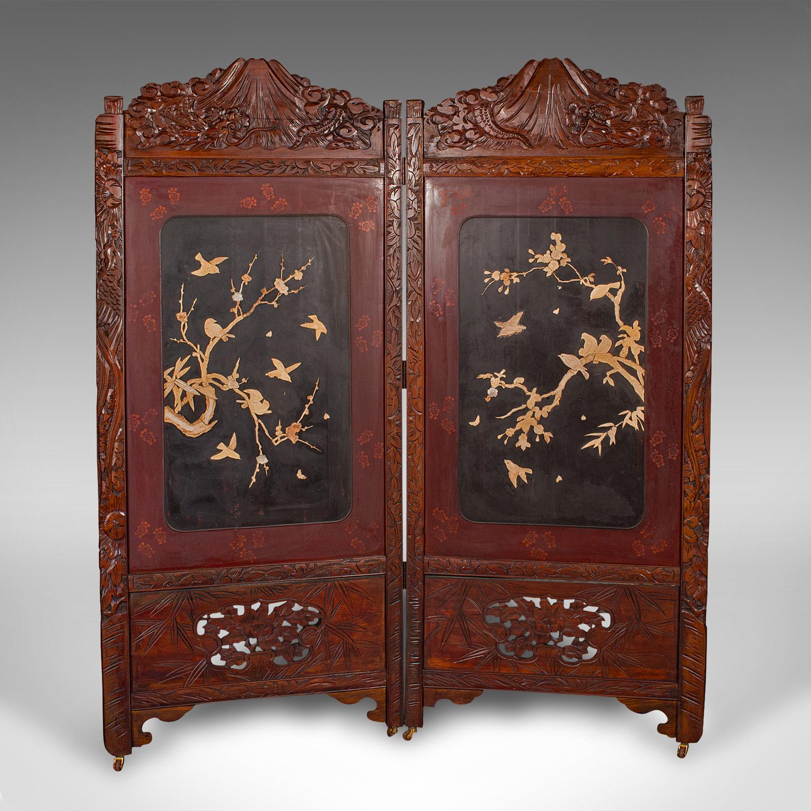This is a captivating Japanese two-panel privacy screen, dating to the late Art Deco period, circa 1940. This elegant mahogany room divider exudes period charm, showcasing skilled craftsmanship and traditional motifs.

Striking Art Deco-era Japanese