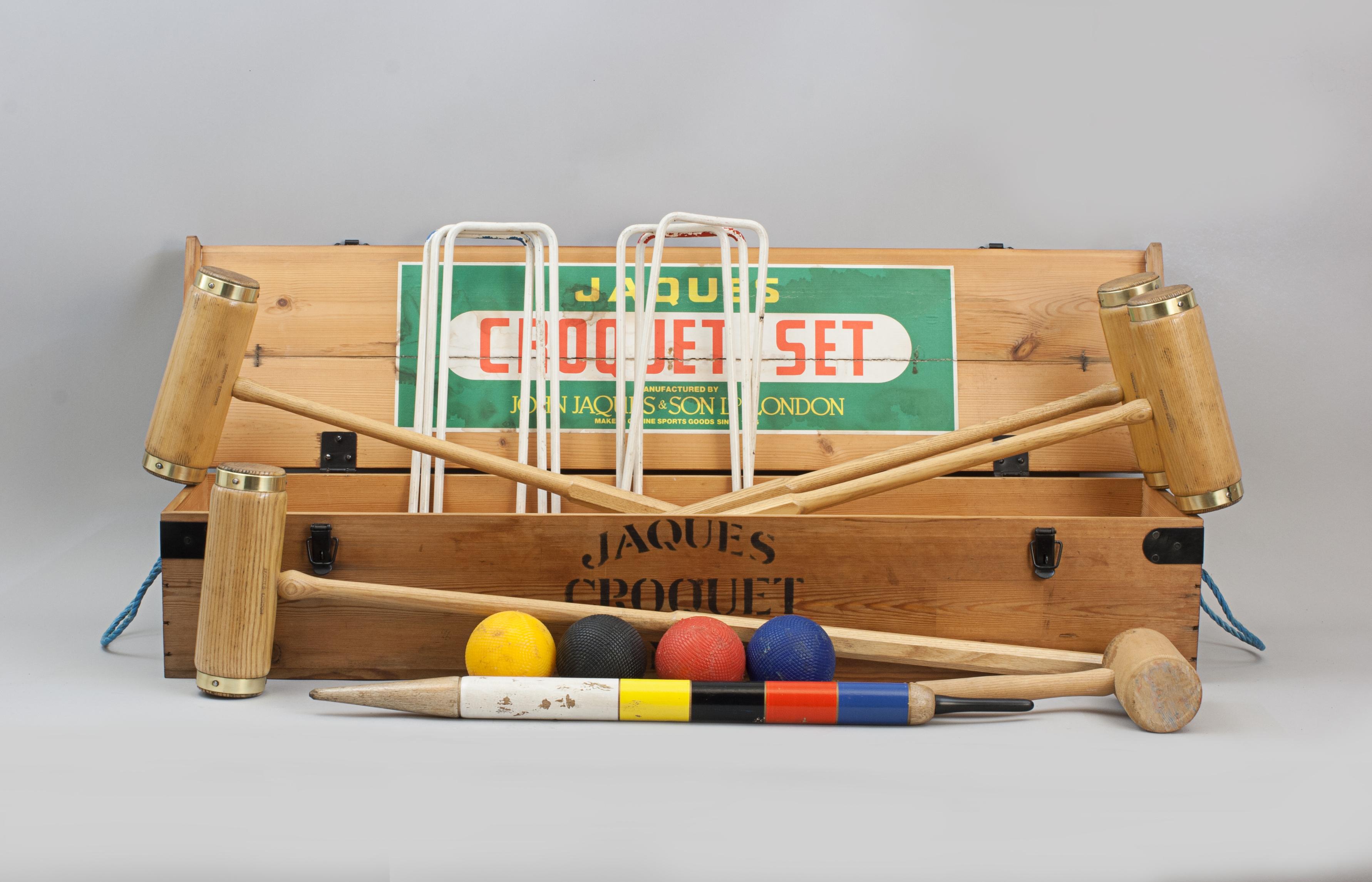 Vintage Jaques 'Oxford' Croquet Set.
A Jaques garden croquet set in original pine box with four brass bound ash mallets. To complete the set there are four coloured balls in the standard croquet colours, six bent metal hoops, one winning post and a