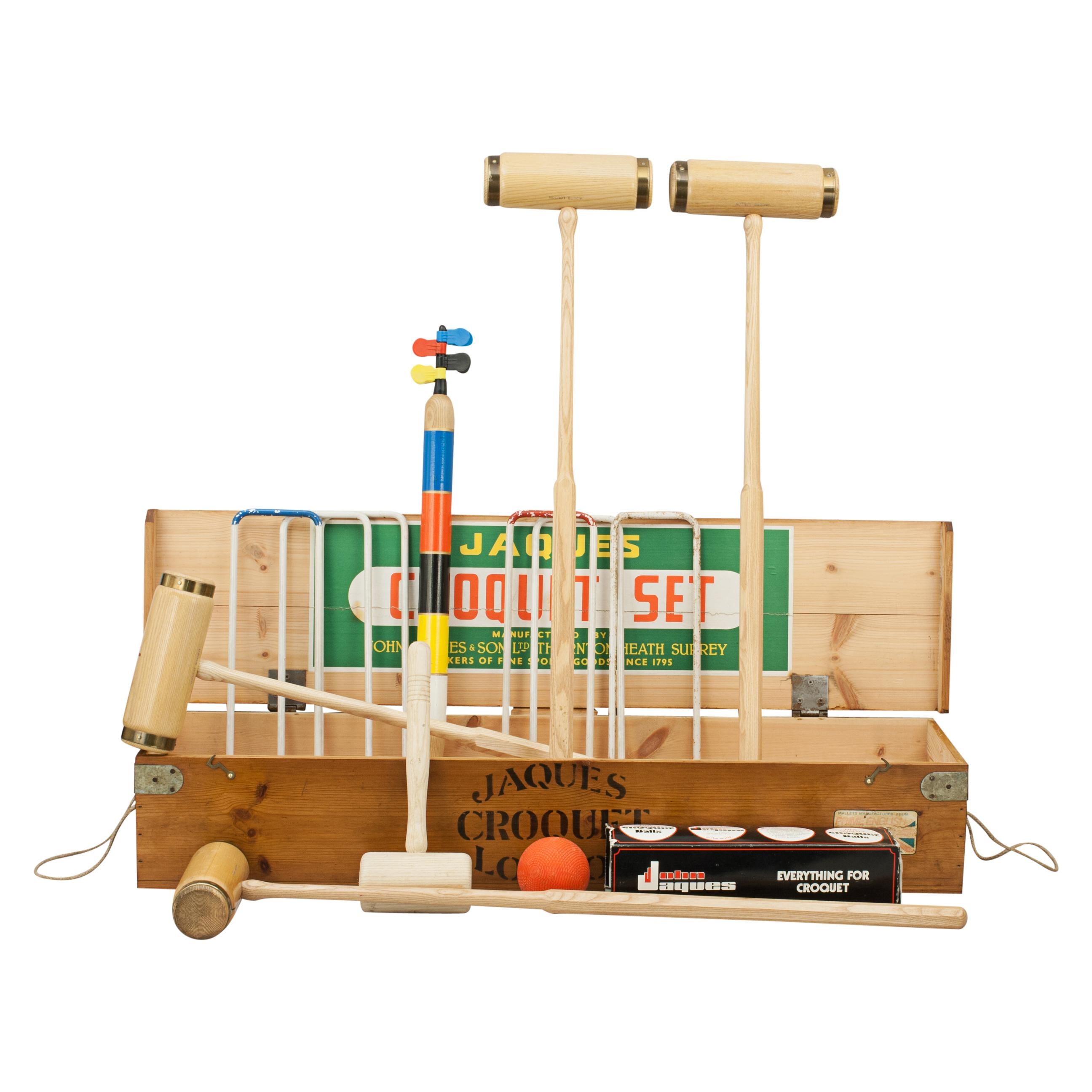 Jaques brassbound croquet set.
A Jaques croquet set in original pine box with four brass bound ash mallets. To complete the set there are four colored balls in the standard croquet colors, six bent metal hoops, wooden mallet, 4 sprung clips and one