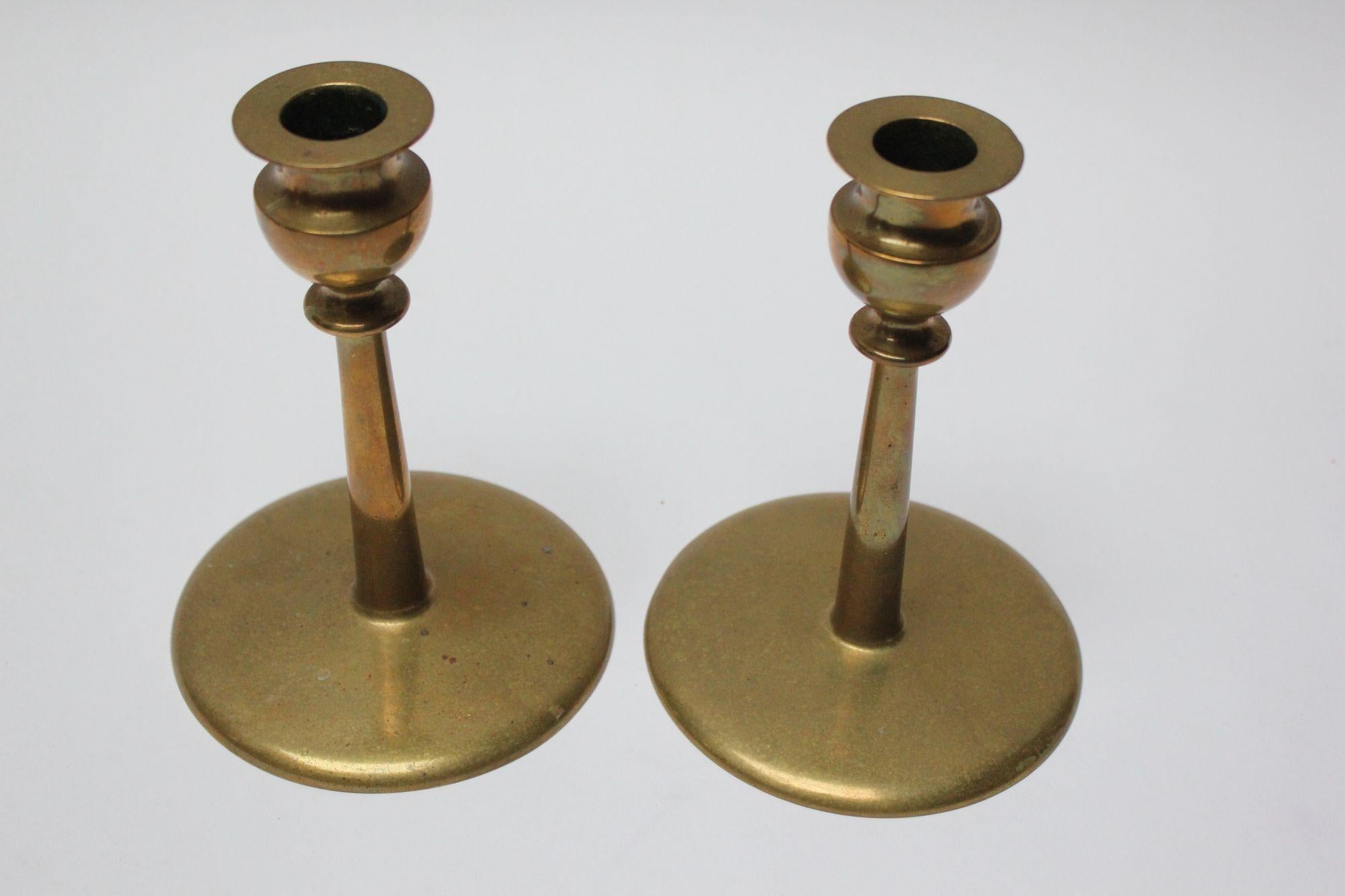 Mid-century brass turned candlesticks, each with bulbous bobeche and cylindrical stem on circular, disk base.
Beautifully aged, showing natural patina, a few scuffs/tarnish spots (unpolished).
Measures: Height 6.25