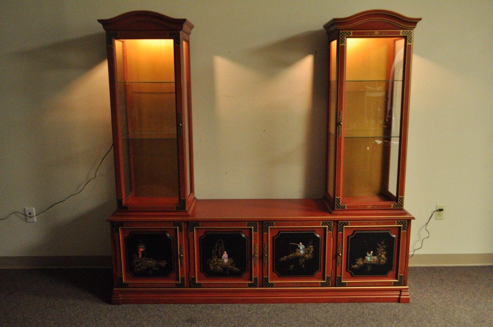 Vintage Chinoiserie / Oriental style three piece display cabinet by Jasper Cabinet Company. Item features high quality solid wood construction, red painted finish with gold trim, hand-painted scenic front and side panels, curved glass upper doors,