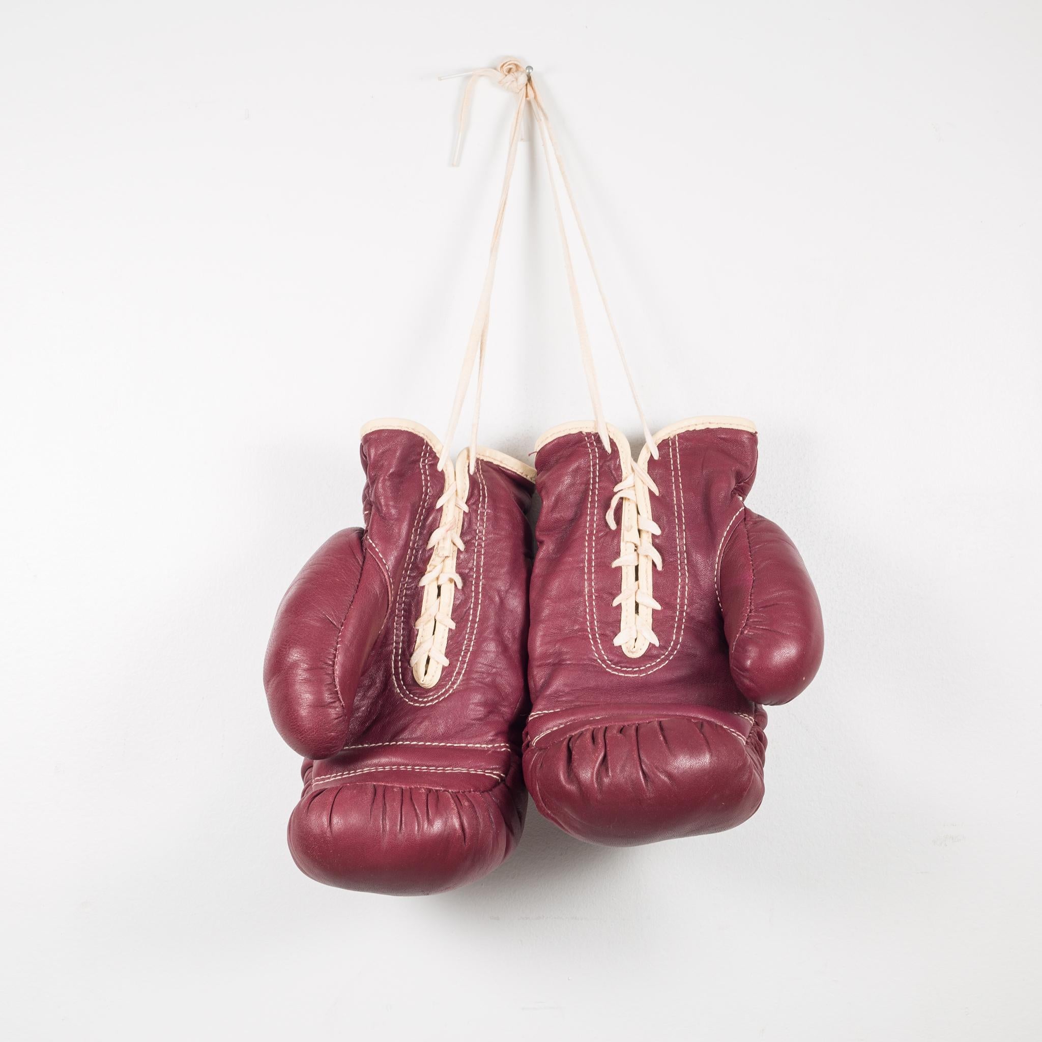 About

Two pairs available. Price is per pair.

These are authentic vintage boxing gloves with reddish, brown leather. Each glove has tan leather piping and laces. The leather is very soft and is good condition. Stamped J.C. Higgins label on