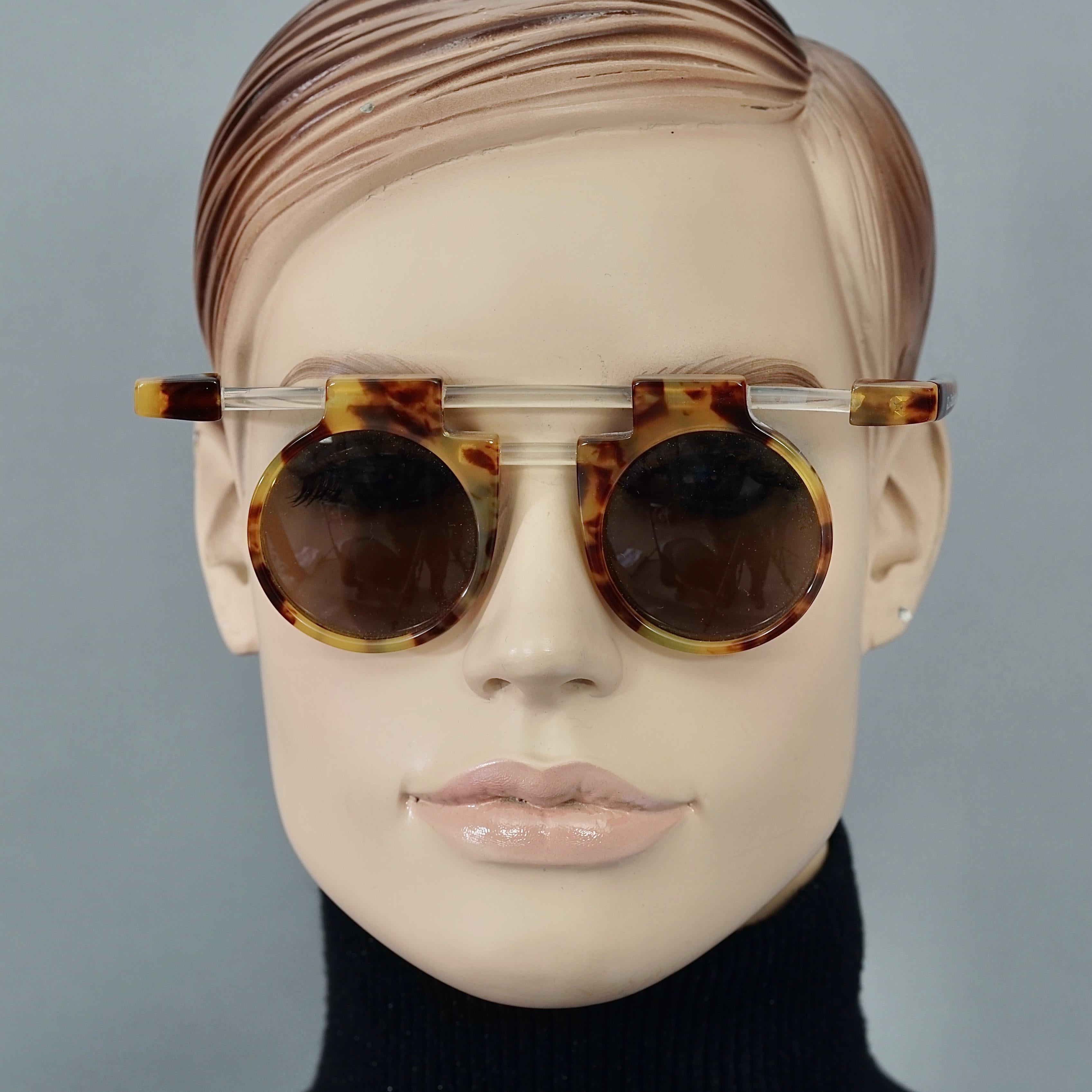 Vintage JEAN CHARLES de CASTELBAJAC Lucite Tortoiseshell Futuristic Sunglasses

Measurements:
Frame Height: 2 inches (5.10 cm)
Hinge to hinge Width: 5.70 inches (14.5 cm)
Temples: 5.39 inches (13.7 cm)

Features:
- 100% Authentic JEAN CHARLES de