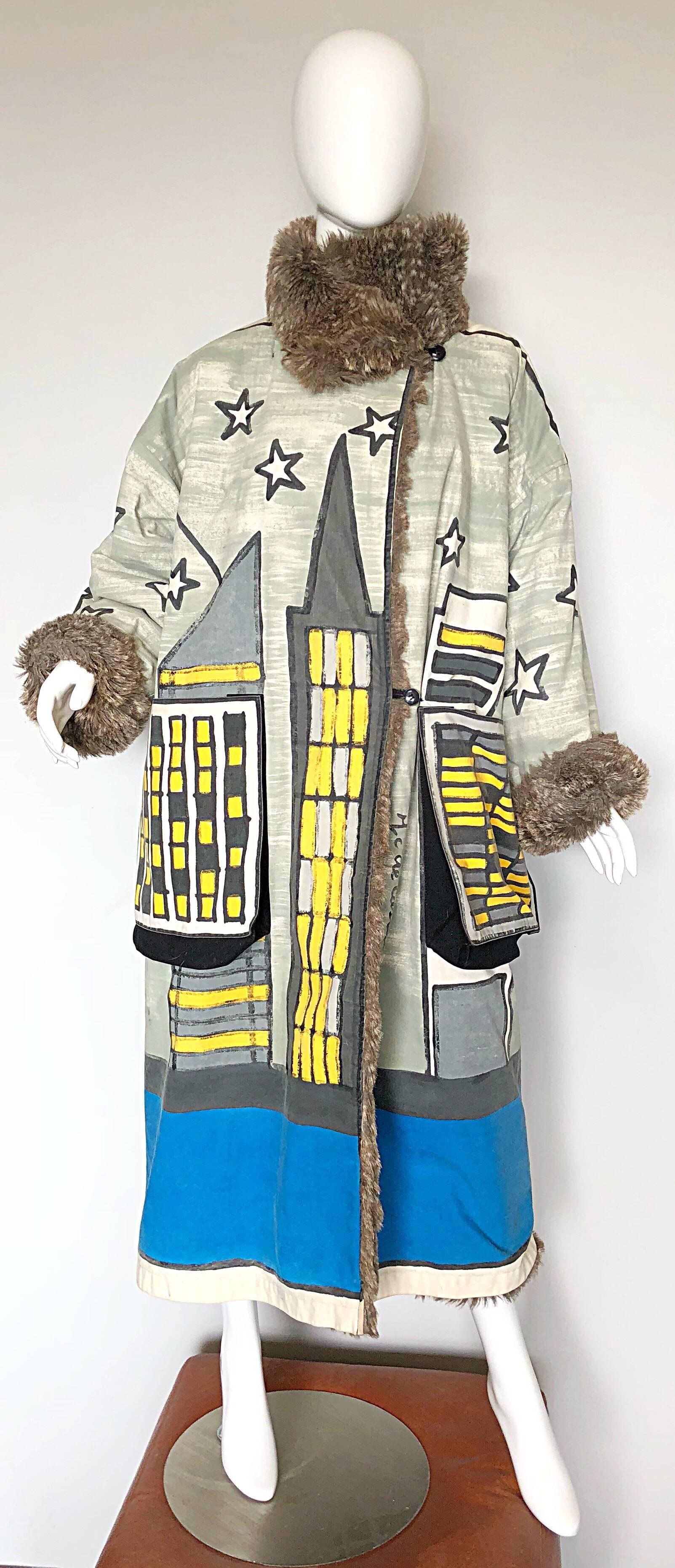 Fabulous one of a kind musuem piece vintage 
JEAN CHARLES de CASTELBAJAC hand painted oversized reversible coat! Features a painted skyline with a moon, stars and UFO. Vibrant colors of blue, yellow, grey and white. Lining is a super soft gray faux