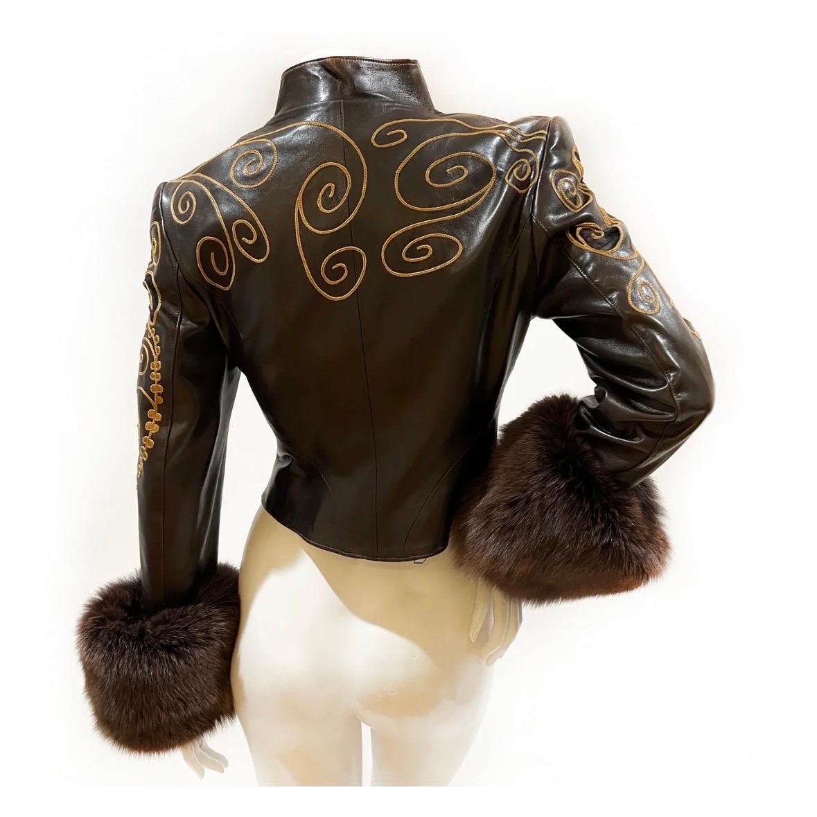 Vintage embellished jacket by Jean Claude Jitrois
Circa 1980s 
Brown leather
Fox fur cuffs
Decorative, whimsical, gold colored embroidery 
Angular collar
Small mesh cutouts throughout 
Button-front closure
Textured gold-metal buttons
Shoulder