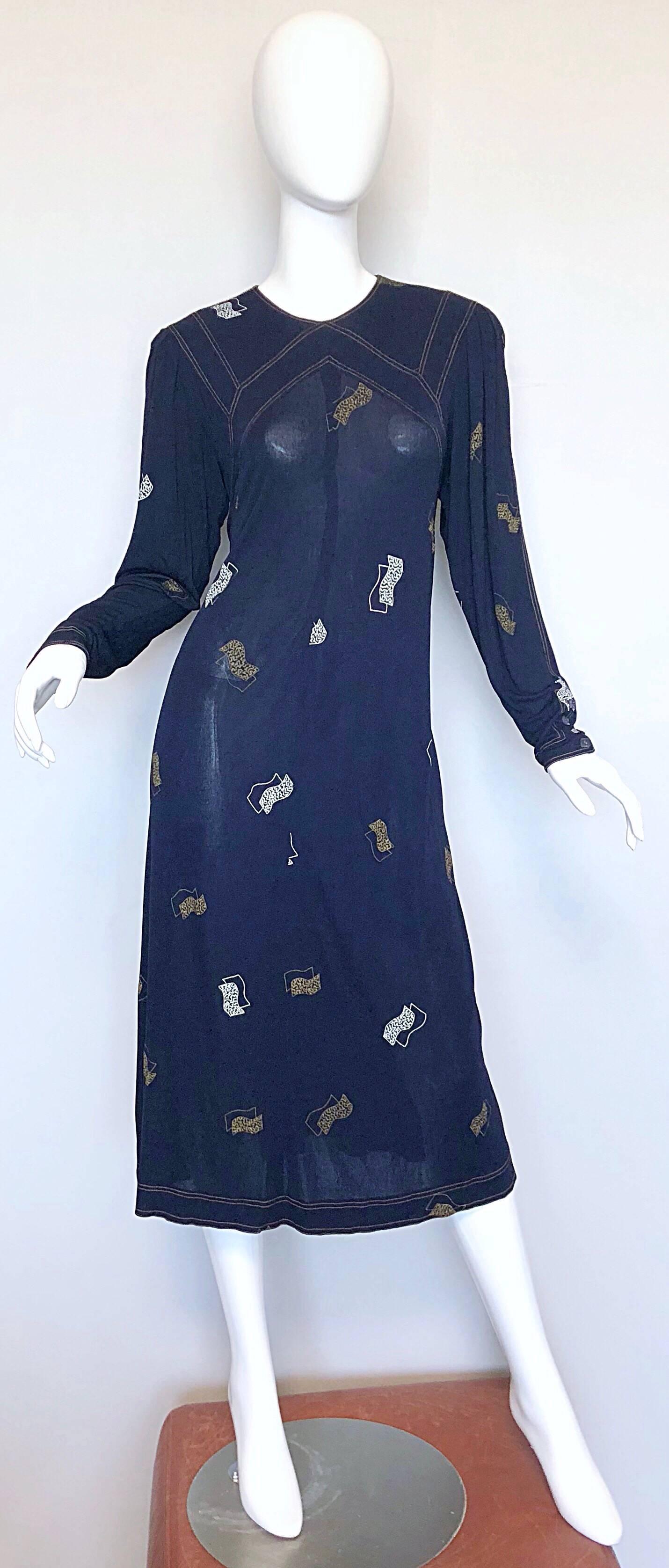 Sophisticated 80s does 30s JEAN MUIR navy blue hand painted Art Deco style rayon jersey long sleeve midi dress! Features hand painted prints in a muted gold and white. Features POCKETS at each side of the hips. Clear acrylic diamond shaped buttons