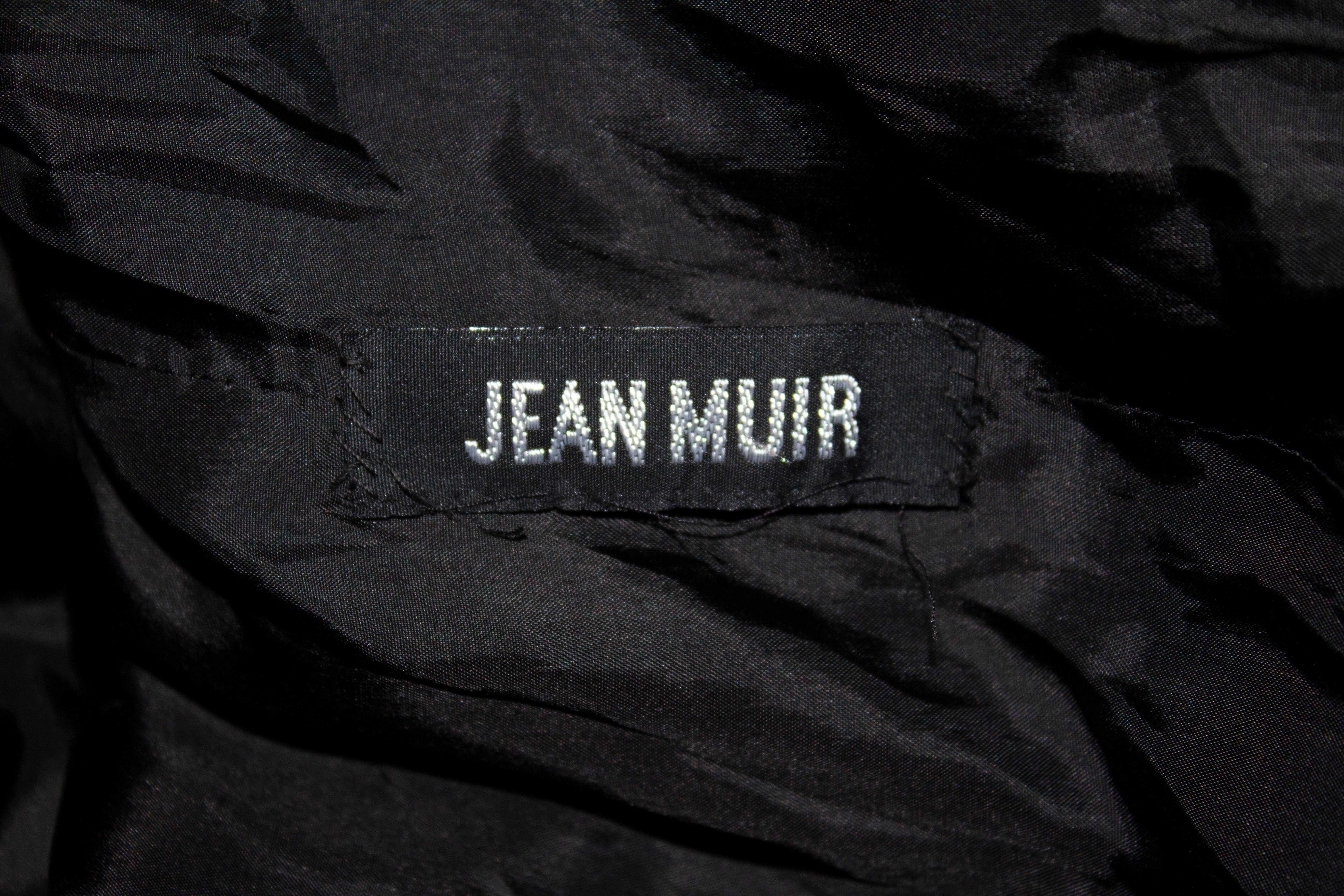 A charging vintage suede jacket by Jean Muir ( main line), ideal for Spring /Summer.
In a black, super soft suede the jacket has a decorative trim on the collar and cuffs, front button opening, 5'' vent at the back and small original shoulder pads. 