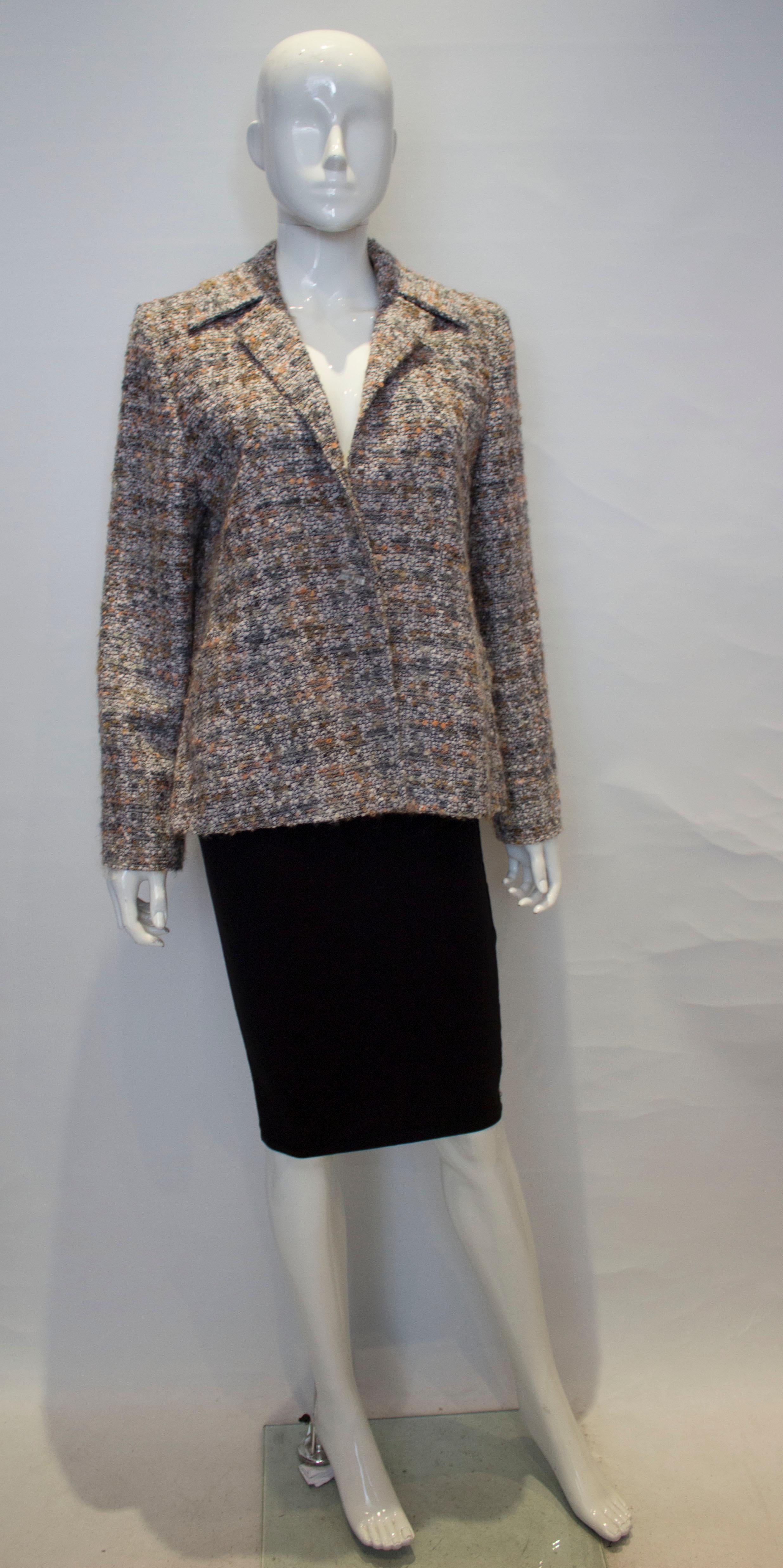 A great jacket for Fall by Jean Myuir, main line. The jacket is in a pretty mix of colours, grey, peach and ivory. It has a cut away collar, is fully lined and has two front pockets.