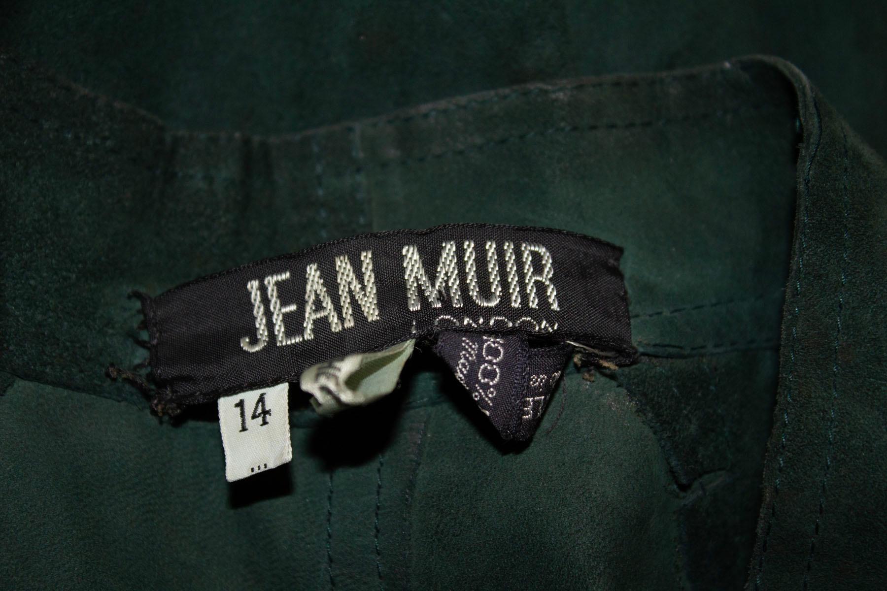 A great dress for Fall / winter by Jean Muir , main line. The dress is in Christmas tree green suede. It has a button through front opening with an elasticated waist and button cuffs. The dress has attractive punch detail on the suede, and is