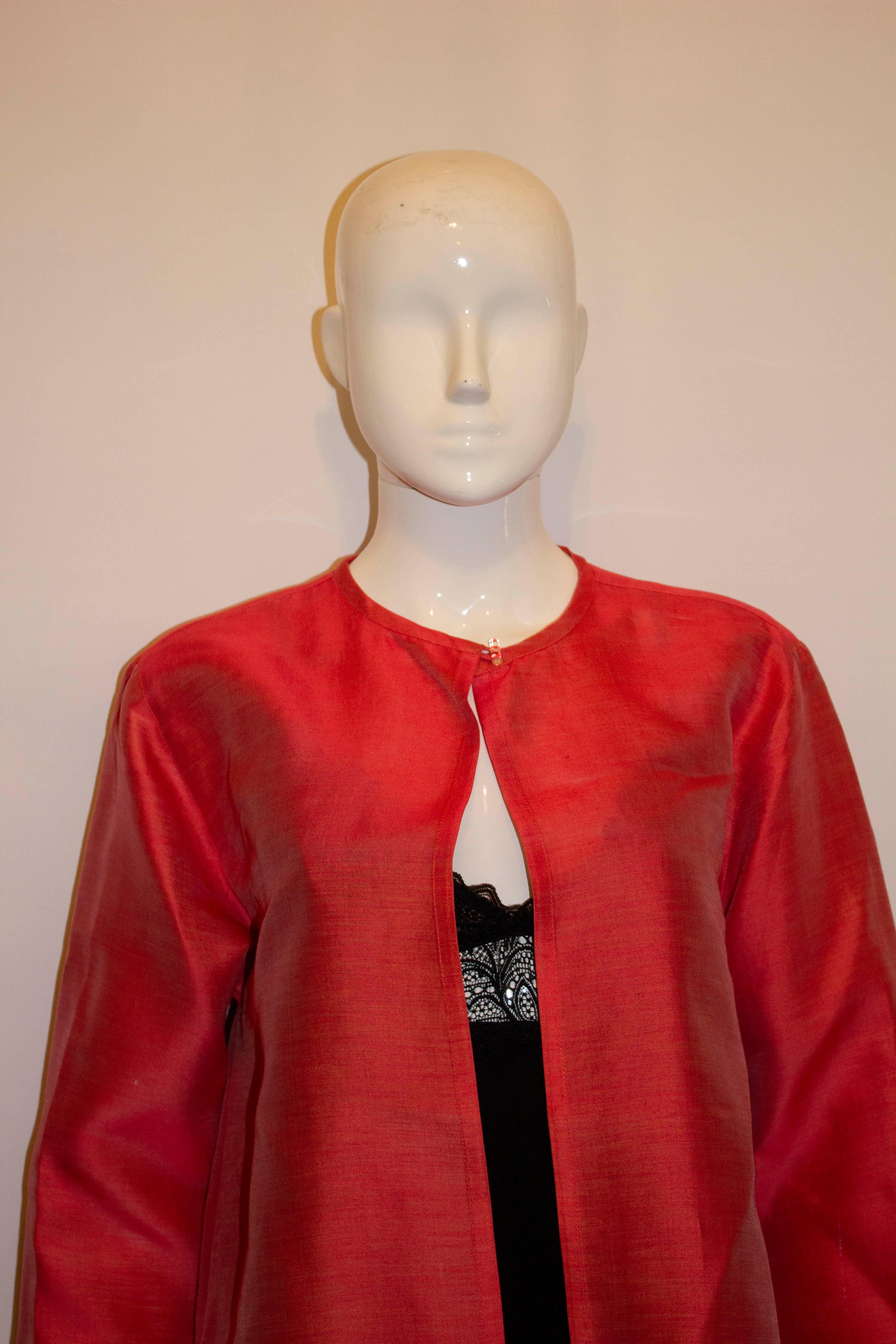 A great and colourful jacket by Jean Muir, main line. The jacket is red on the outside and lined in red . There is an 11'  vent on either side and a top button fastening. 
Made in England, measurements: Bust up to 39'', length 31''