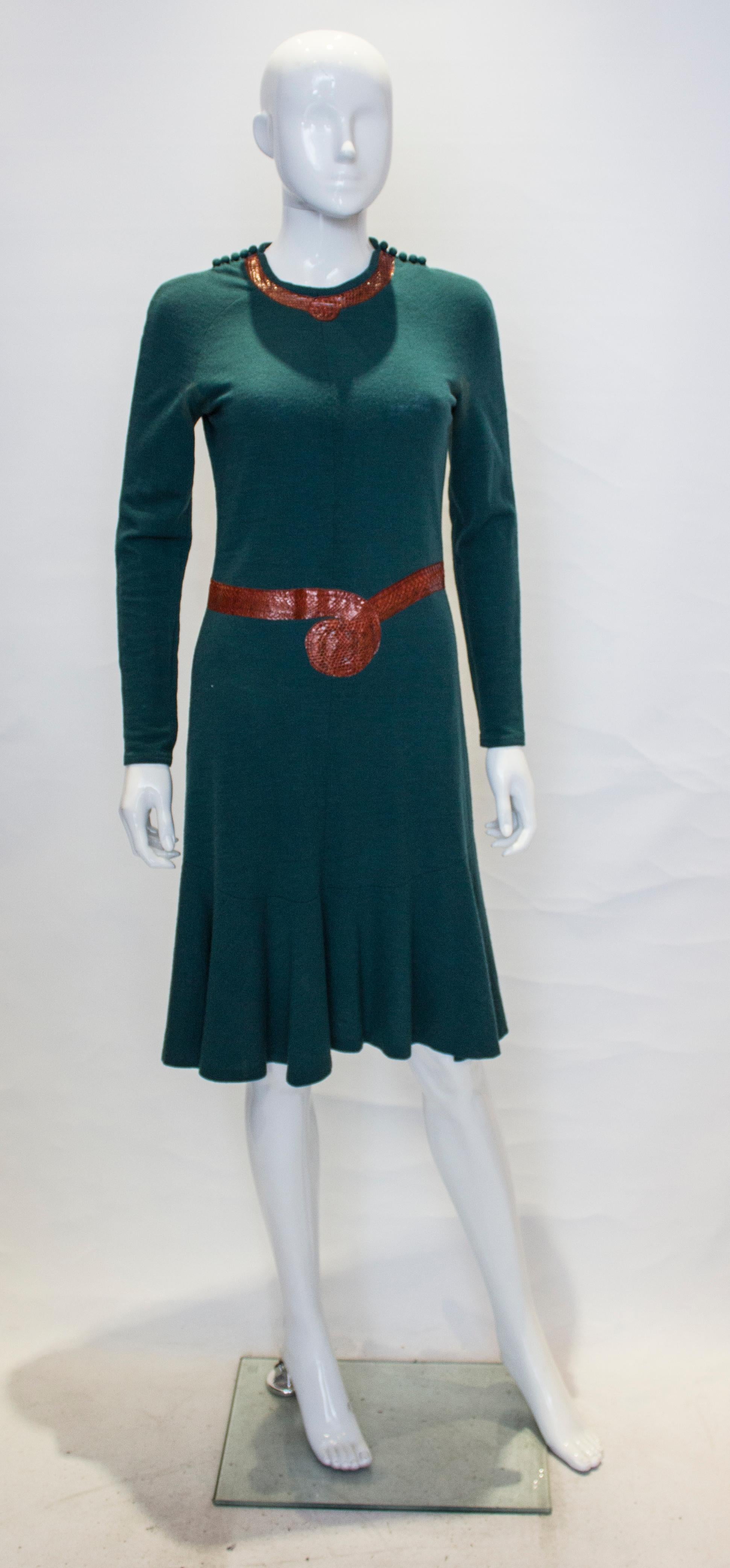 A 1970s by Jean Muir green wool and snakeskin dress. The dress has covered buttons on the shoulder , a back central zip and flared skirt. 